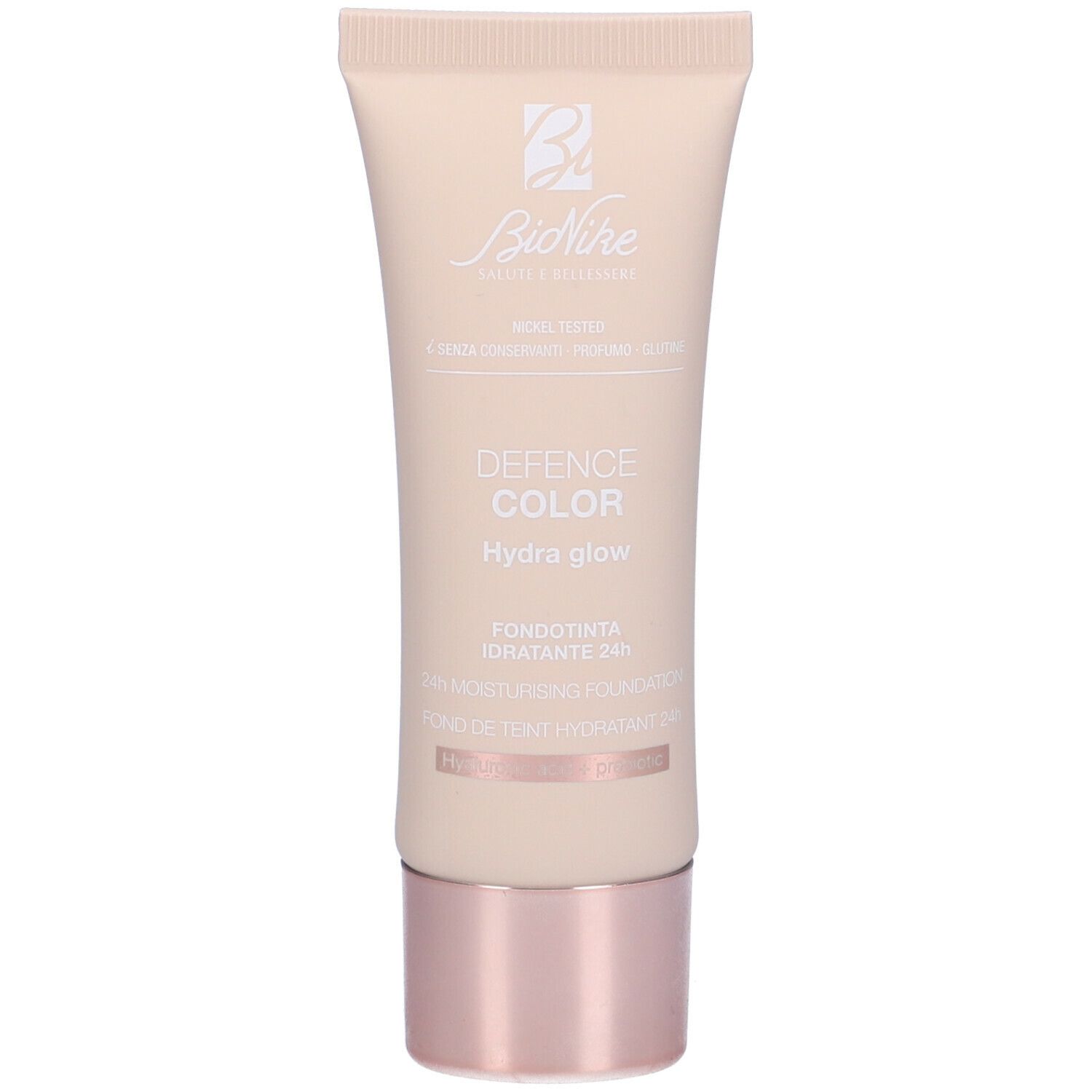 Tubo beige con tappo rosa. Scritta: Defence Color Hydra glow, Fondotinta Idratante 24h.