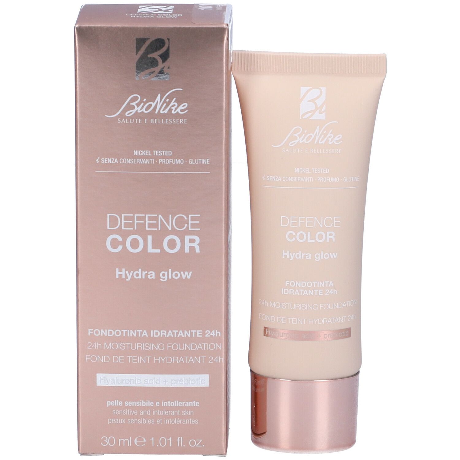 Prodotto e confezione. Tubo beige e scatola rosa. Scritta: Defence Color Hydra glow, 30 ml.