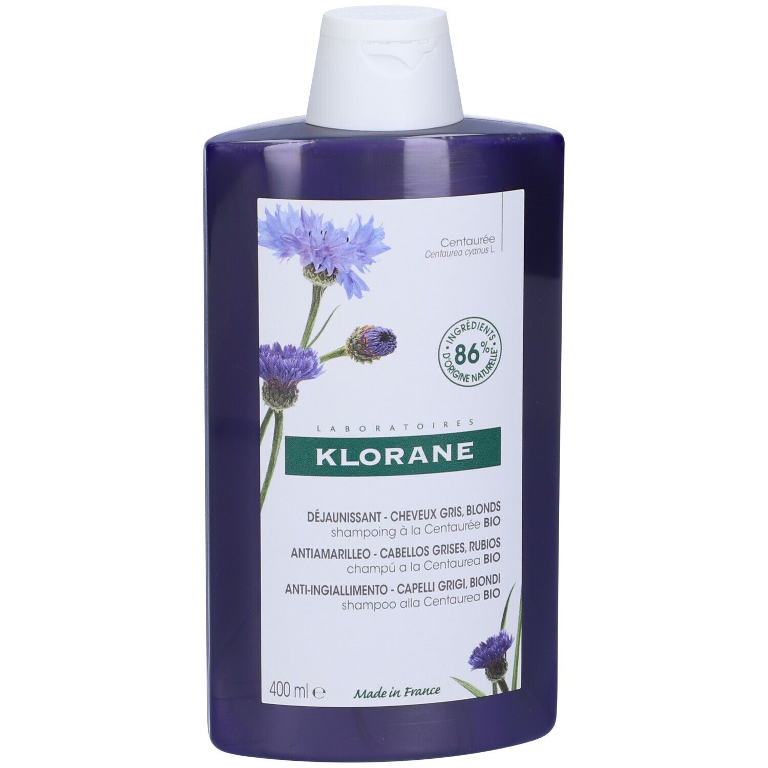 Flacone di shampoo blu con tappo bianco. Etichetta con nome del prodotto, illustrazione di fiordalisi e 86% di ingredienti naturali.