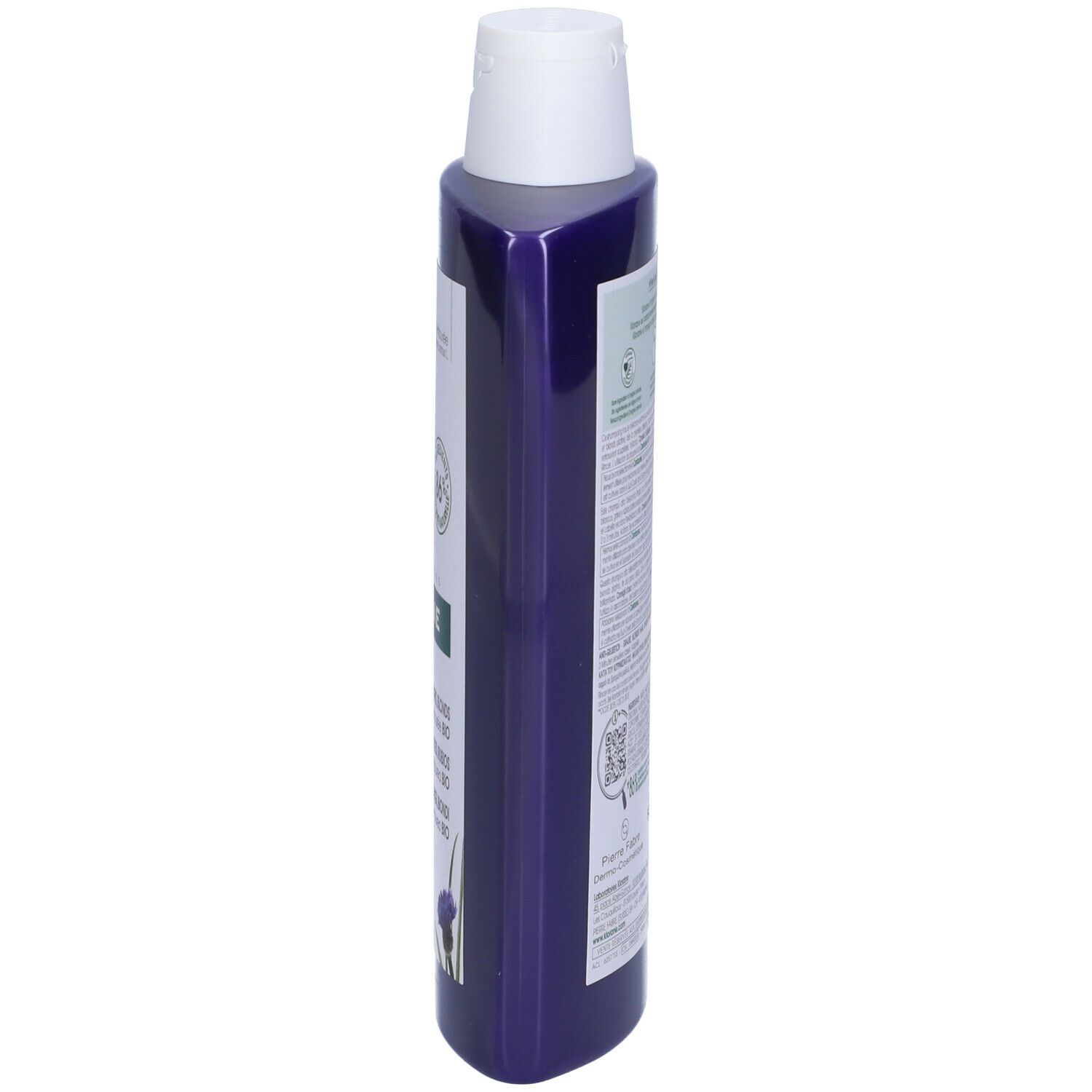 Flacone di shampoo blu, vista laterale. Tappo bianco, etichetta con informazioni sul prodotto e illustrazione di fiordalisi.