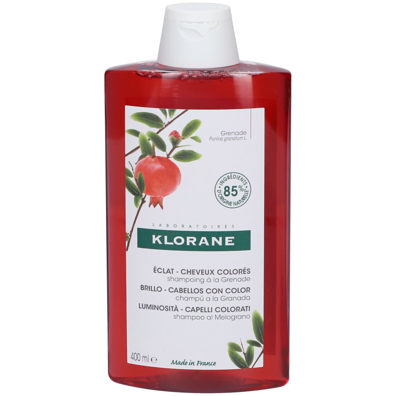 Flacone di shampoo rosso. Tappo bianco. Etichetta con melograno e testo: KLORANE, ÉCLAT - CAPELLI COLORATI.