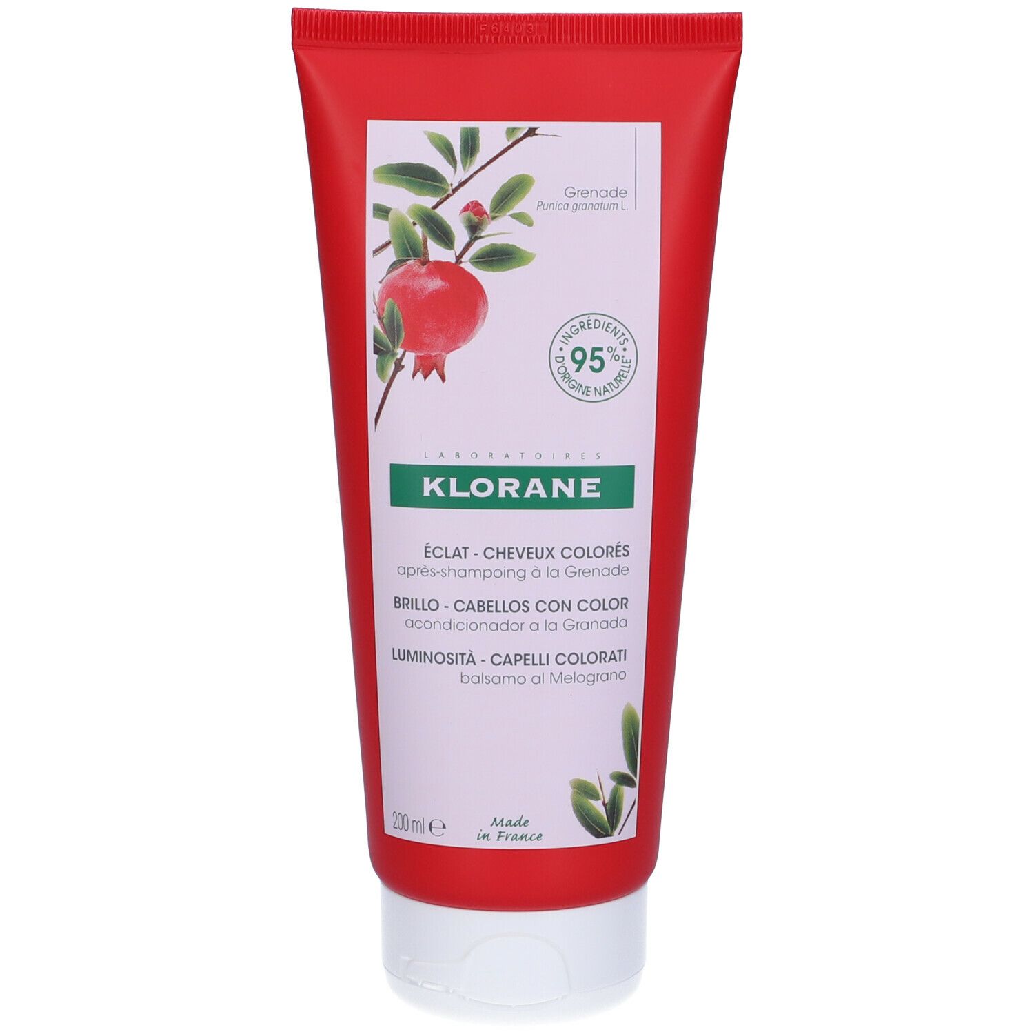Tubo rosso Klorane Balsamo al Melograno. Illustrazione melograno, 95% ingredienti naturali. Testo: Éclat cheveux colorés. Prodotto in Francia.