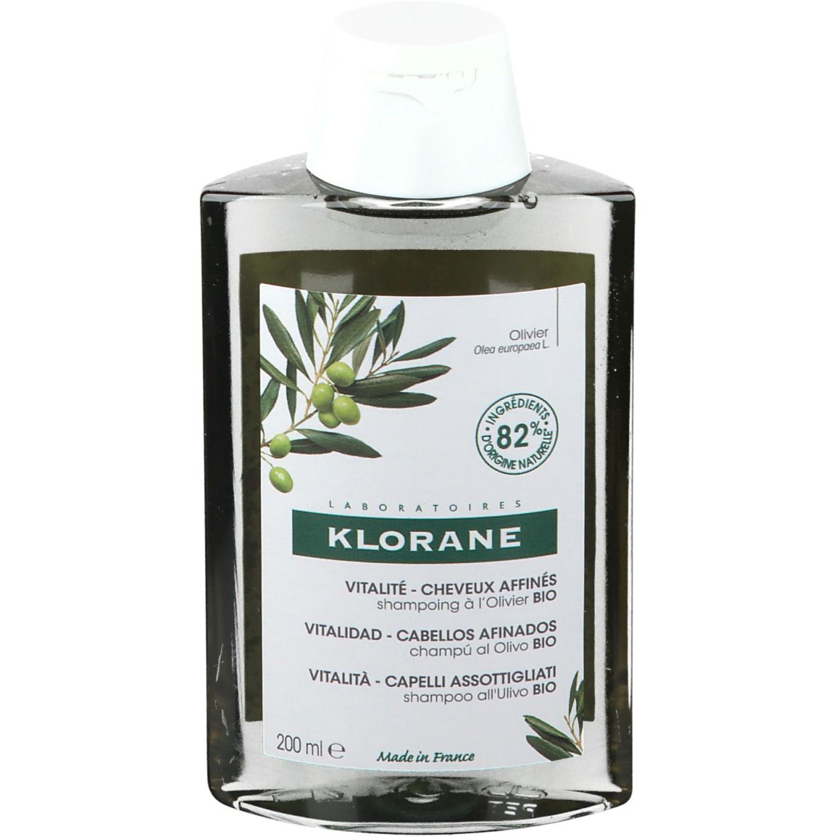 Flacon de shampooing transparent avec bouchon blanc. Inscription: KLORANE, Vitalité - Cheveux Affinés, Shampooing à l'Olivier Bio. Illustration d'olives.