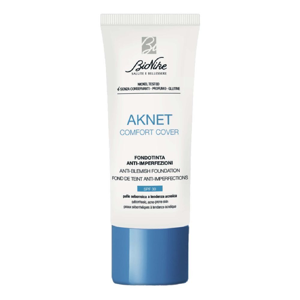 Tubo bianco con tappo blu. Scritta: AKNET Comfort Cover, Anti-imperfezioni, SPF 30. Marchio: BioNike.