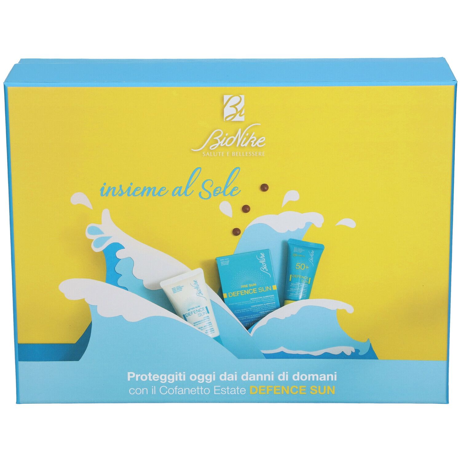 Bionike Travel Kit Speciale Estate. Confezione rettangolare con design giallo e blu. Motivo a onde e immagini dei prodotti.