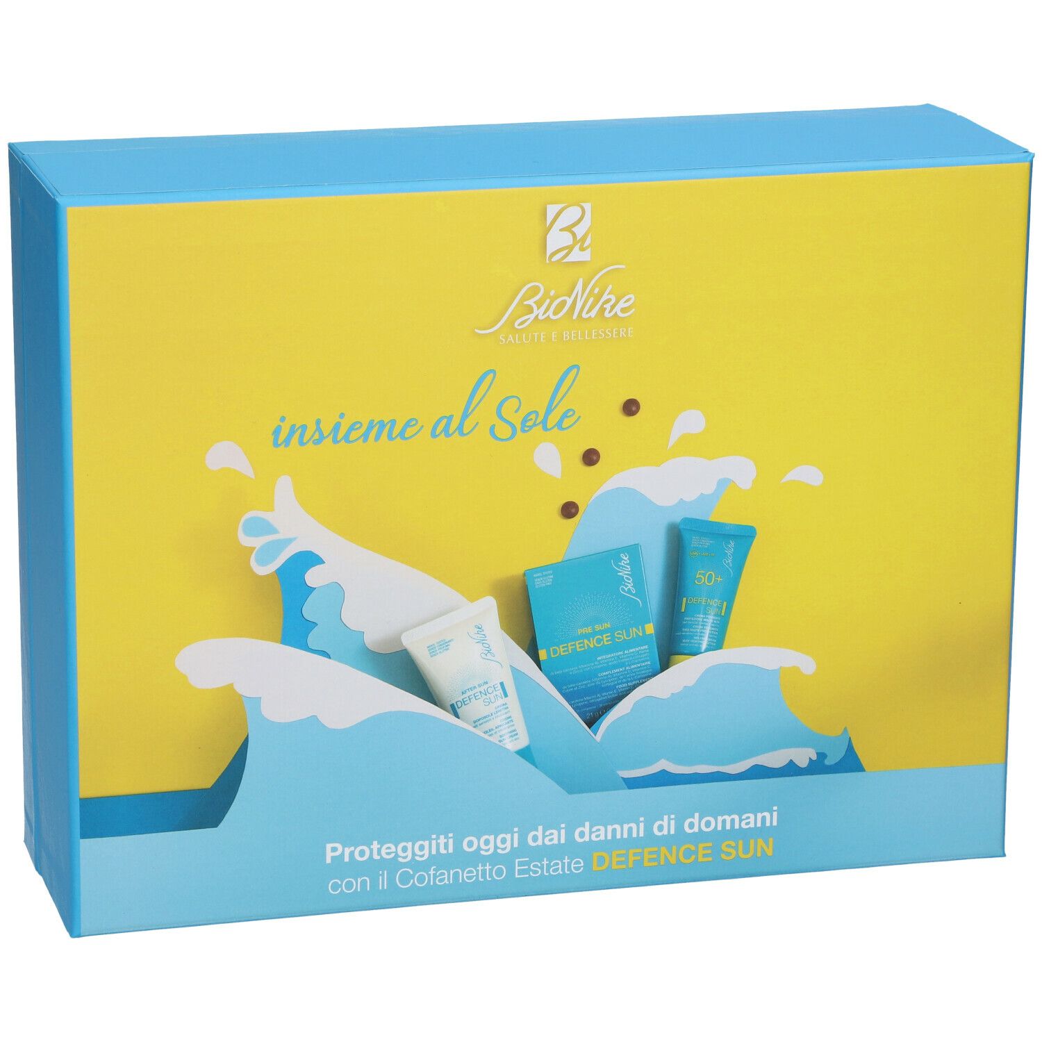 Bionike Travel Kit Speciale Estate. Confezione rettangolare con design giallo e blu. Motivo a onde e immagini dei prodotti.