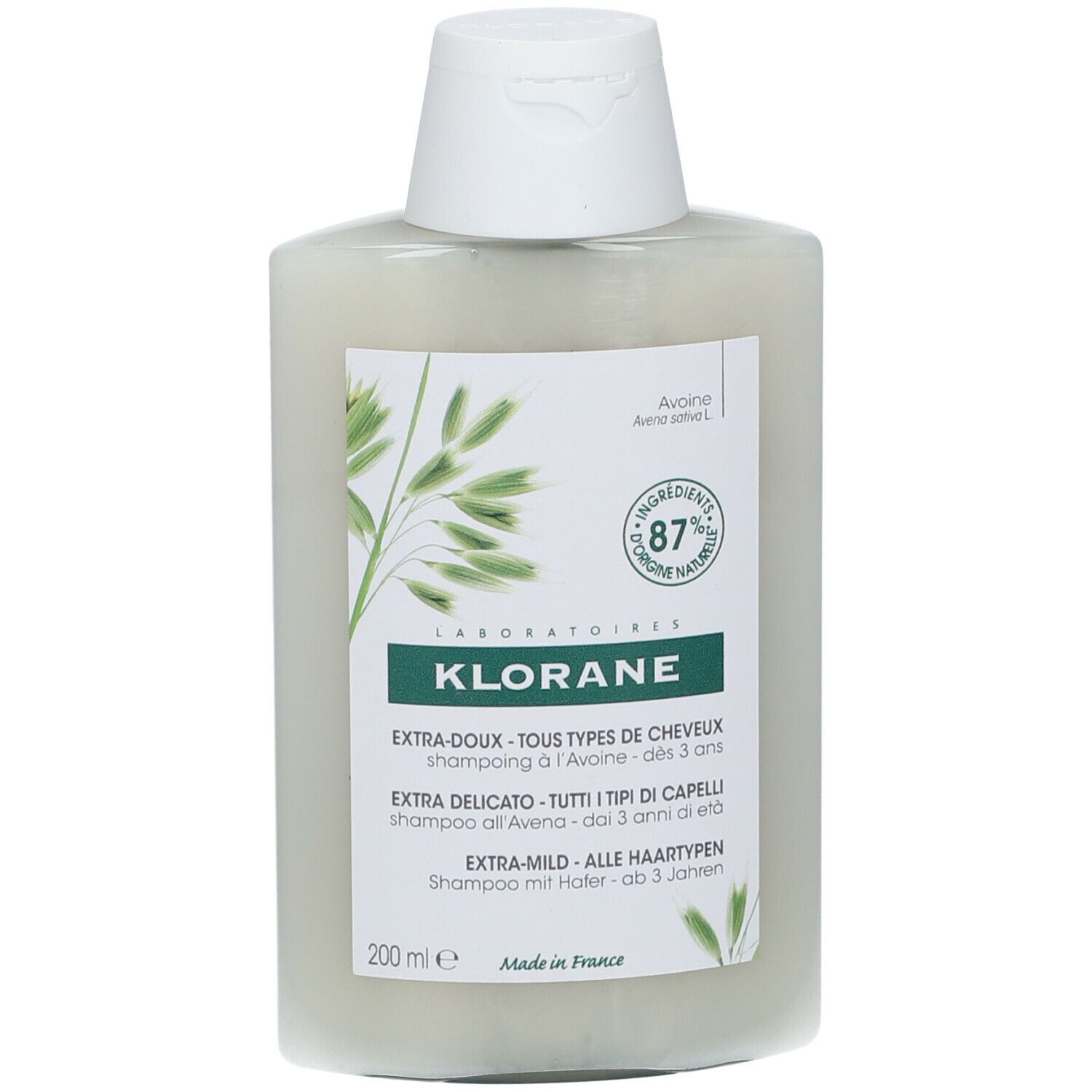 Flacone di shampoo bianco con etichetta verde. Testo: Klorane, Extra-Doux, tutti i tipi di capelli, dai 3 anni.