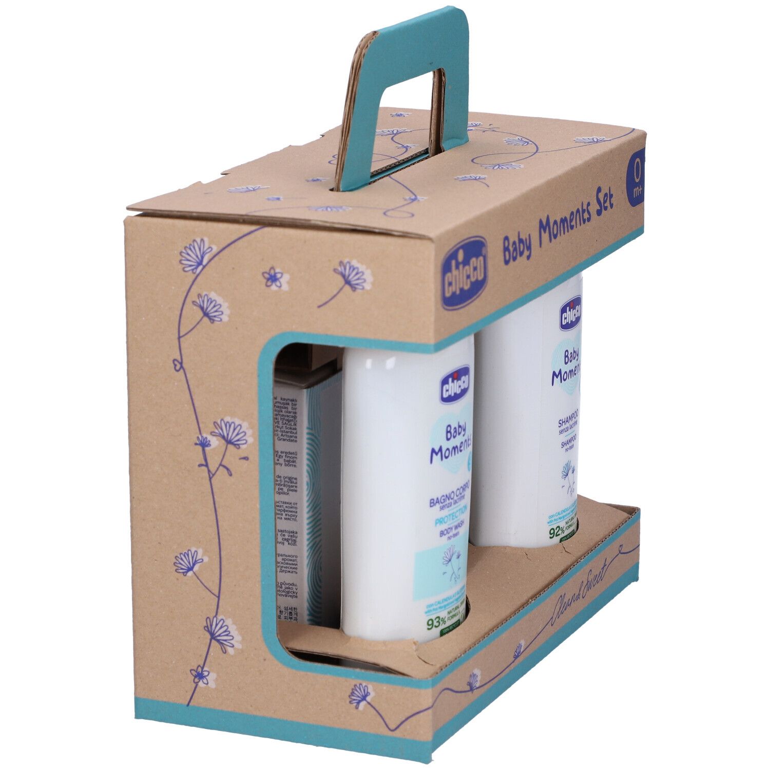 Set di prodotti per l'infanzia in confezione di cartone con manico. Contiene flaconi e sapone. Scritta: Baby Moments, 0m+.