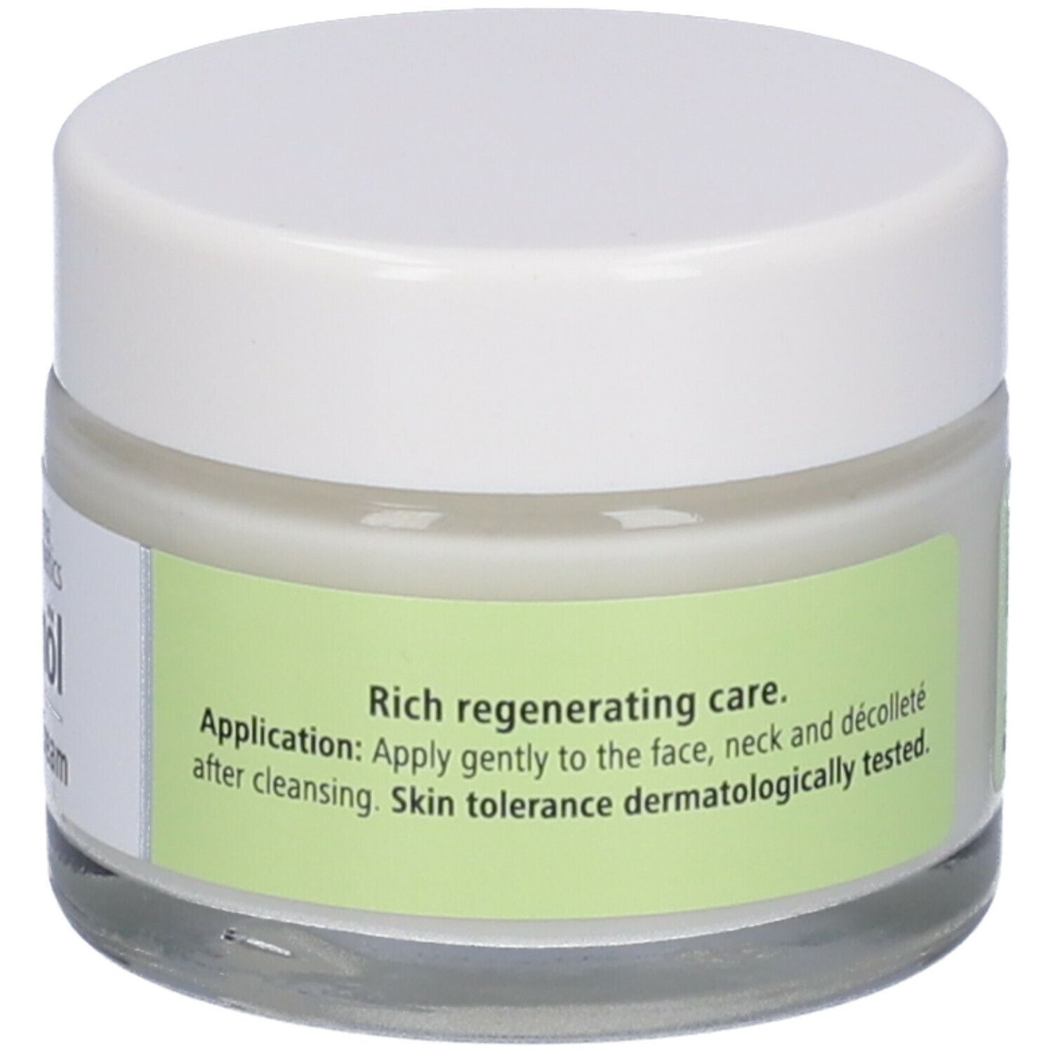 Creme-Glas mit weißem Deckel. Etikett mit Anwendungshinweisen und dermatologischer Verträglichkeit.