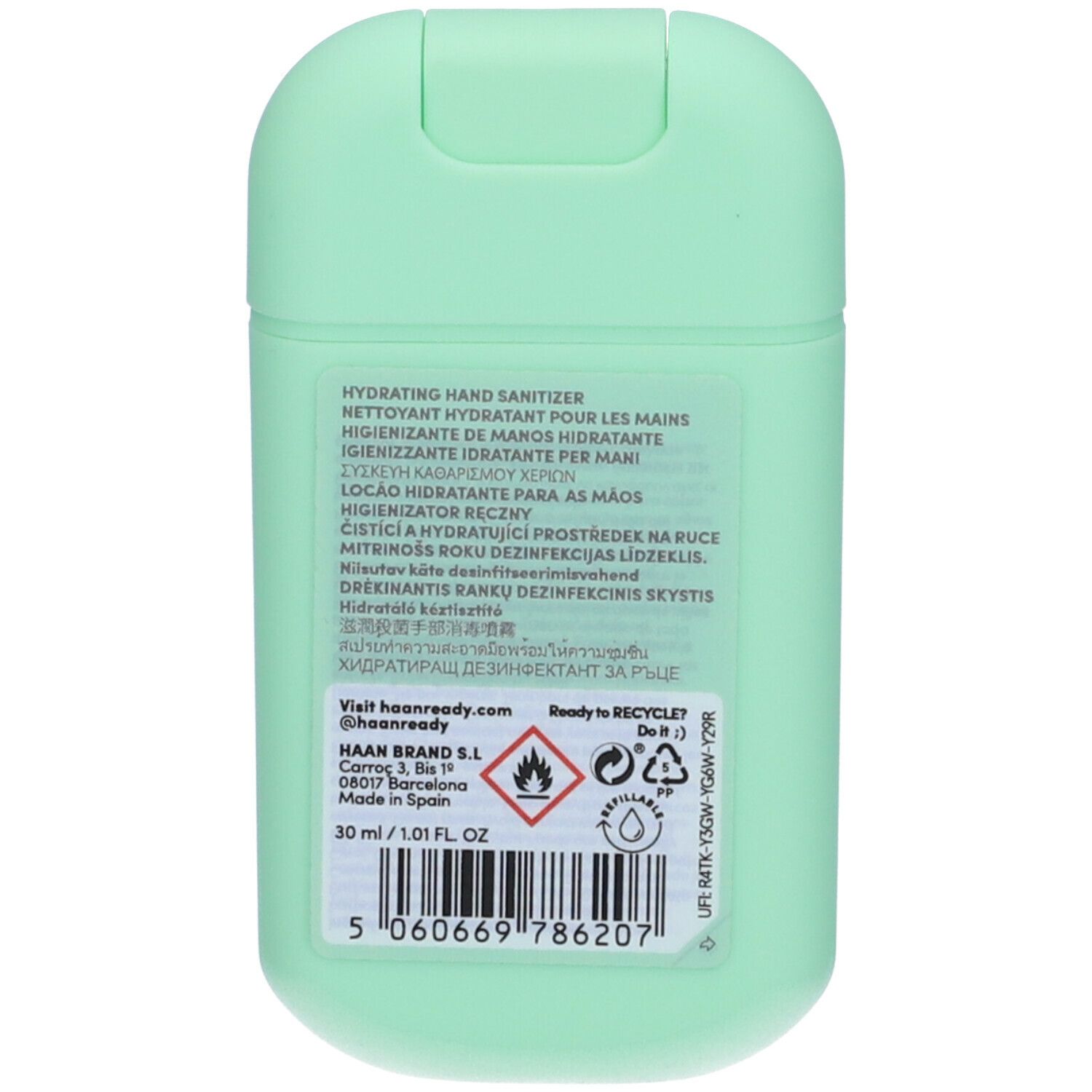 Retro di un contenitore di igienizzante mani verde chiaro. Informazioni multilingue, simbolo di riciclo, 30 ml.