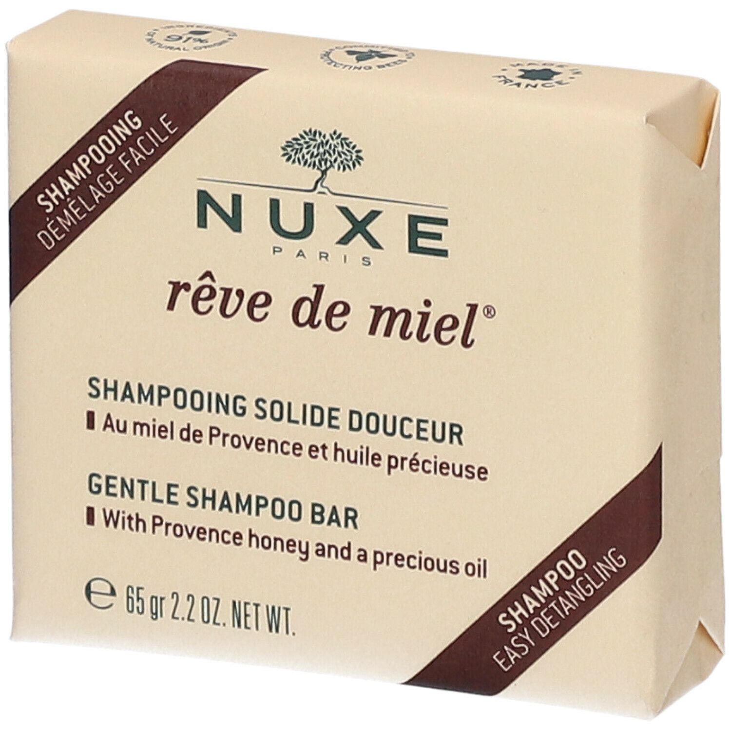 Shampoo solido confezionato. Forma rettangolare, marrone chiaro. Scritte: Nuxe, rêve de miel, Shampooing Solide Douceur, 65 gr.