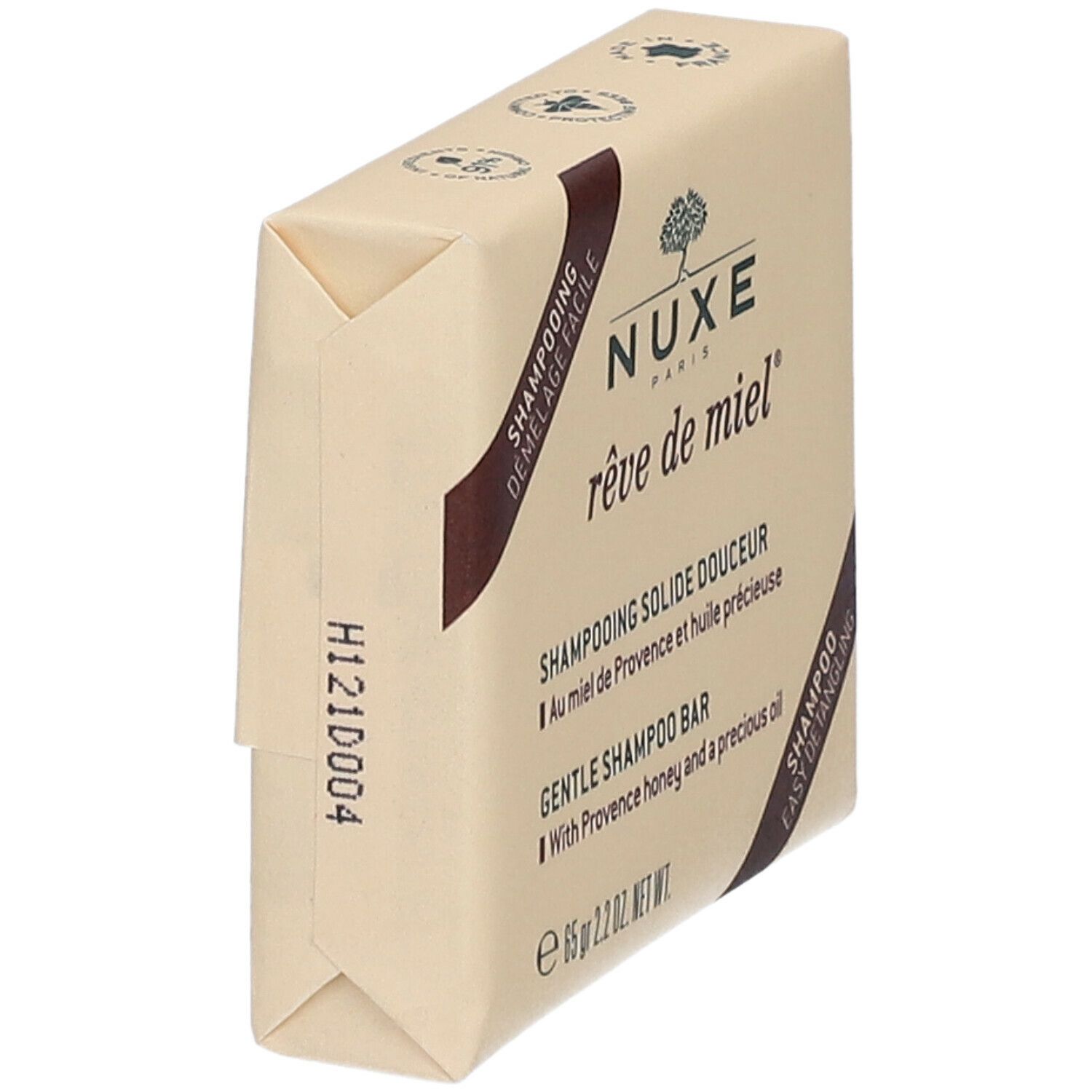 Shampoo solido confezionato. Forma angolare, marrone chiaro. Scritte: Nuxe, rêve de miel, Shampooing Solide Douceur, 65 gr.