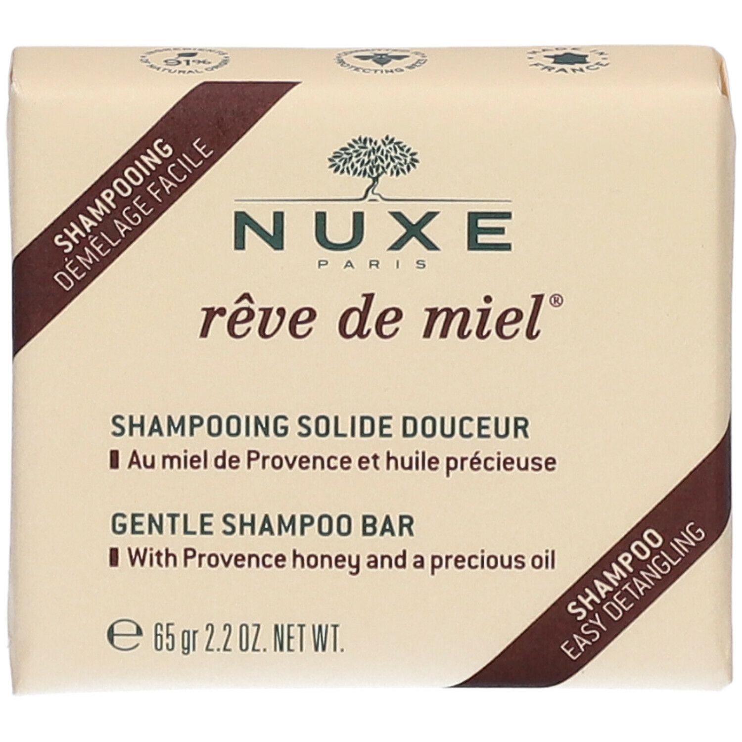 Shampoo solido. Forma quadrata, rosa chiaro. Scritte: Nuxe, rêve de miel, Shampooing Solide Douceur, 65 gr.