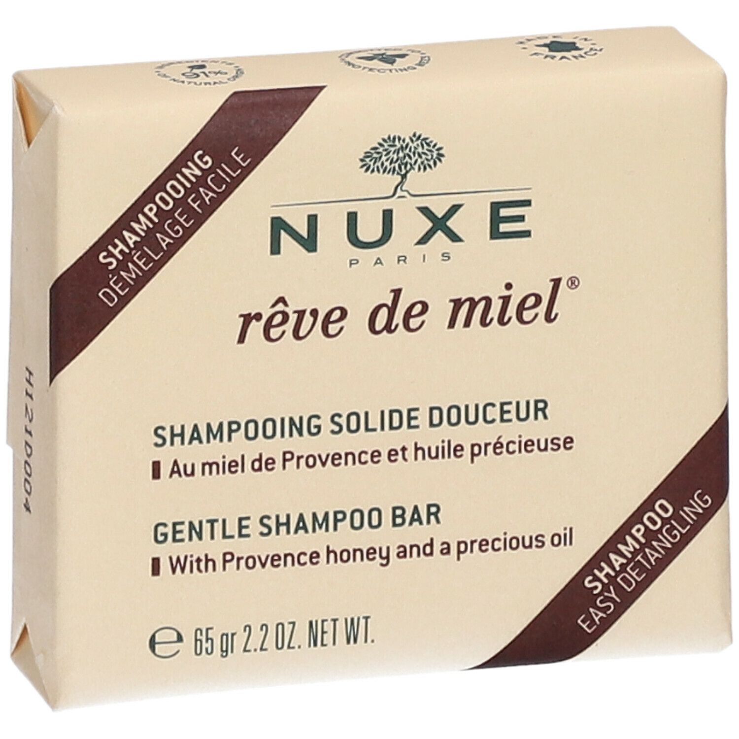 Shampoo solido confezionato. Forma quadrata, rosa chiaro. Scritte: Nuxe, rêve de miel, Shampooing Solide Douceur, 65 gr.