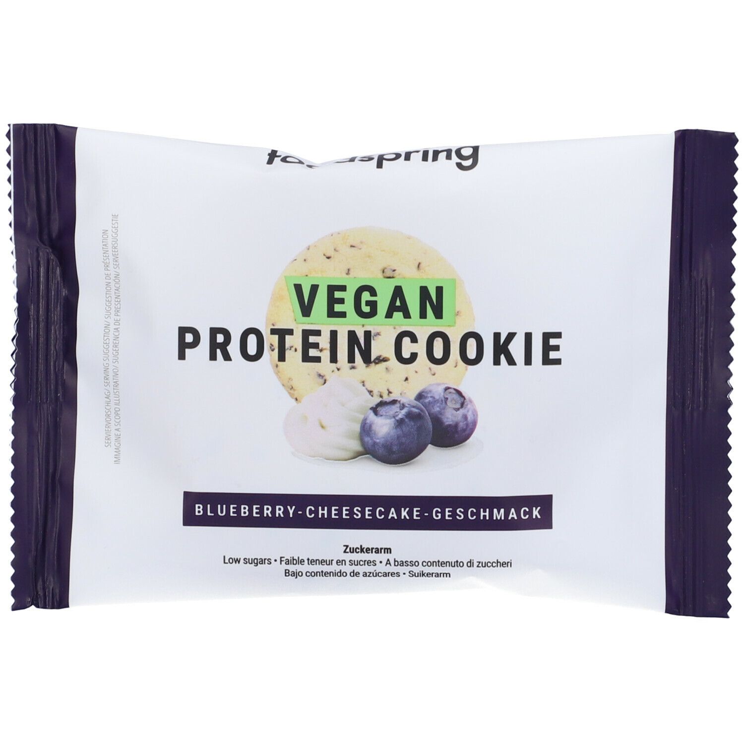 Confezione di Foodspring Vegan Protein Cookie. Scritta: Vegan Protein Cookie, gusto cheesecake ai mirtilli. Immagine: biscotto, mirtilli.