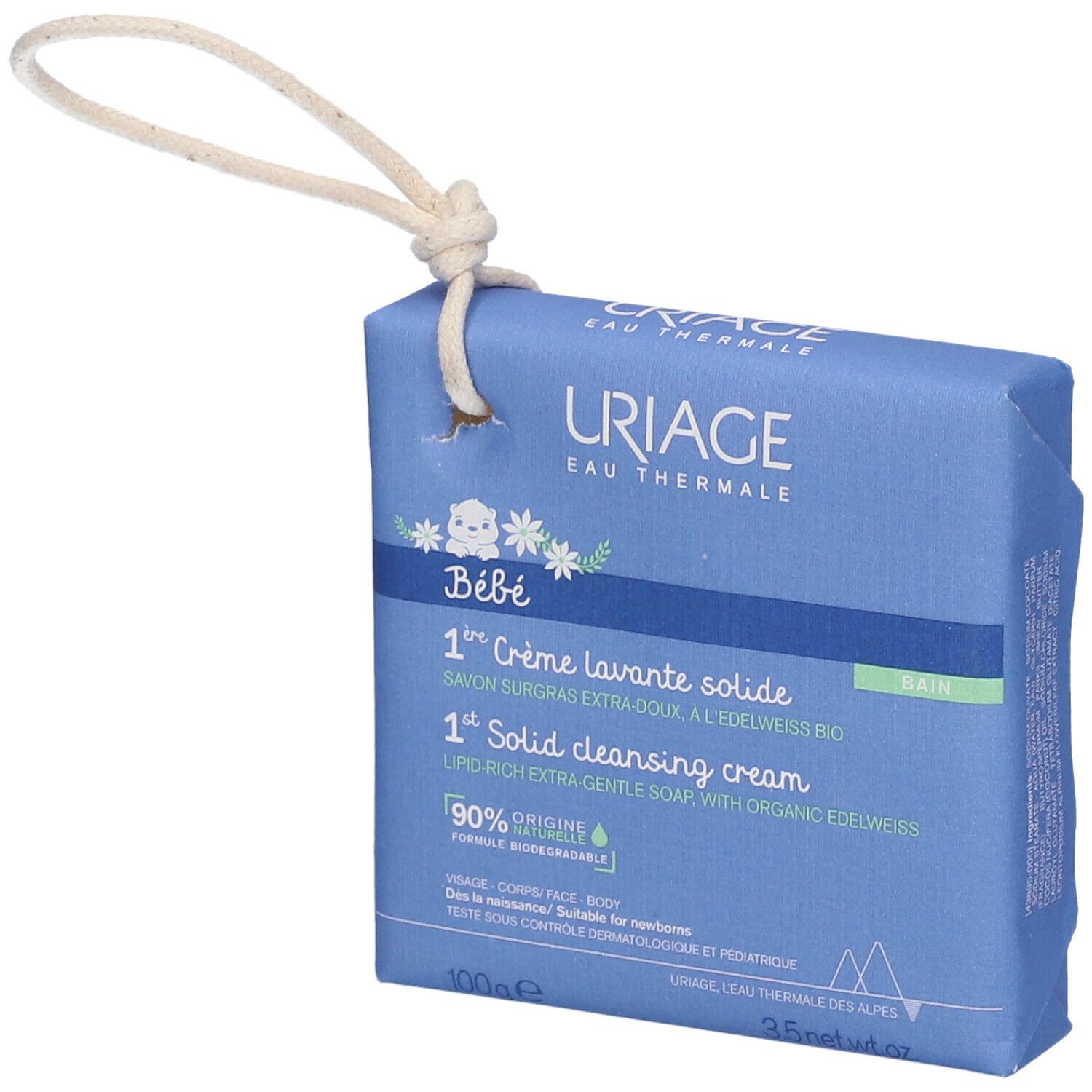 Confezione blu con informazioni sul prodotto. Scritta: URIAGE Bébé, 1a Crème lavante solide. Con cordino per appendere.