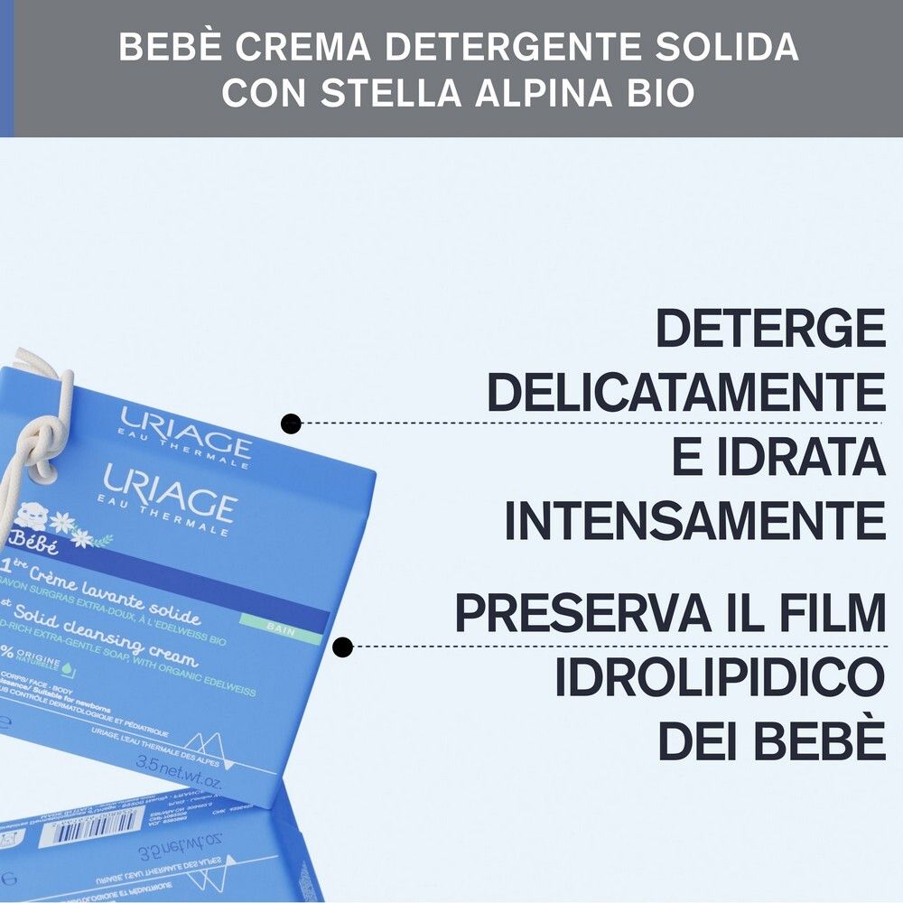 Confezione blu con testo. Testo: URIAGE, Bébé, 1a Crème lavante solide. Deterge, idrata, protegge.