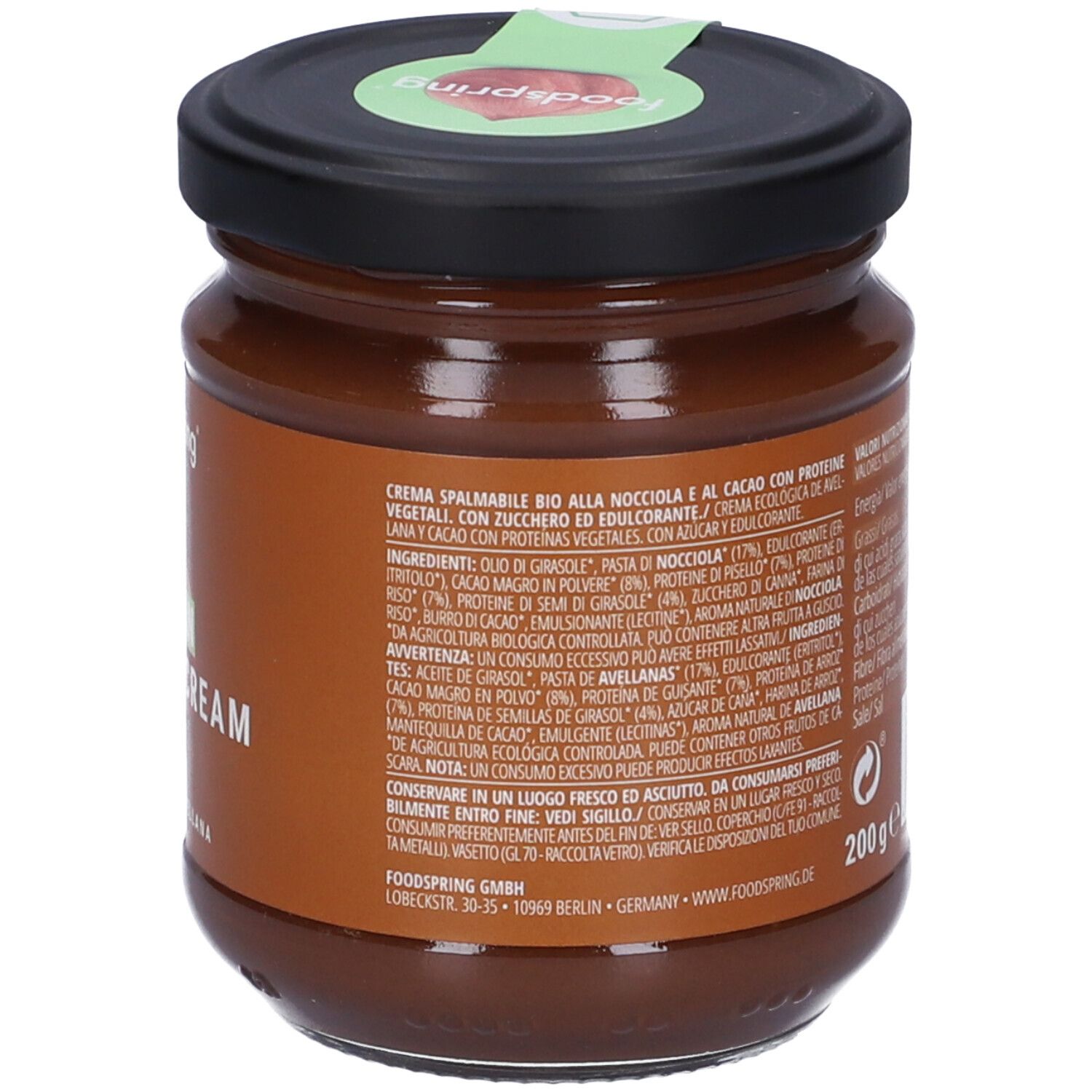 Vasetto Foodspring Bio Crema Proteica Vegana Alla Nocciola. Retro con elenco ingredienti e testo. Coperchio con sigillo verde.