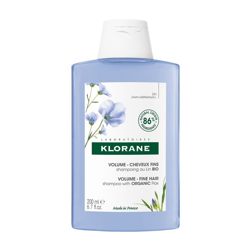 Flacone blu trasparente, tappo bianco. Scritta Klorane, shampoo volume, 86% naturale.