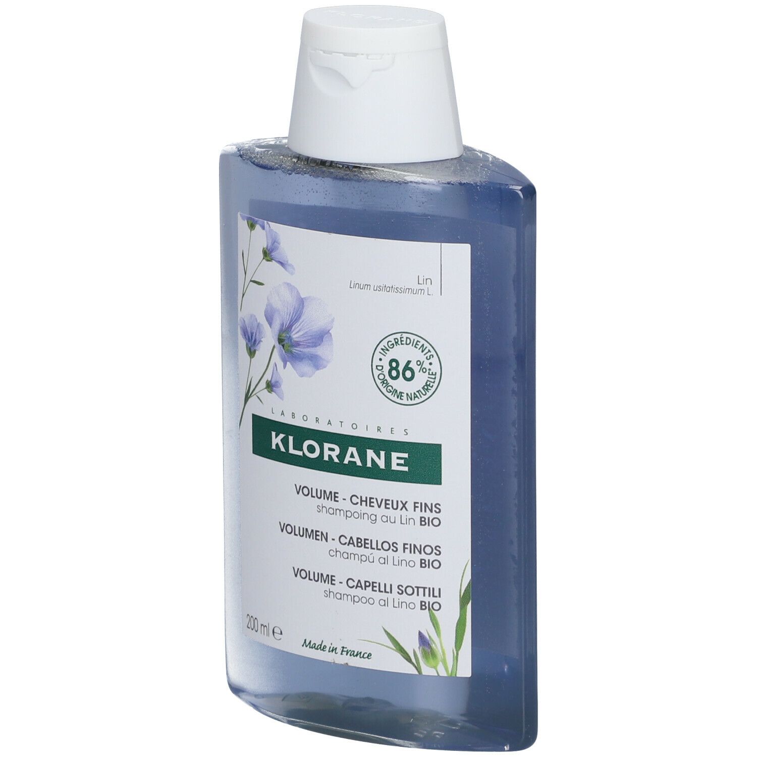 Flacone di shampoo blu con tappo bianco. Scritta Klorane, shampoo volume, 86% naturale.