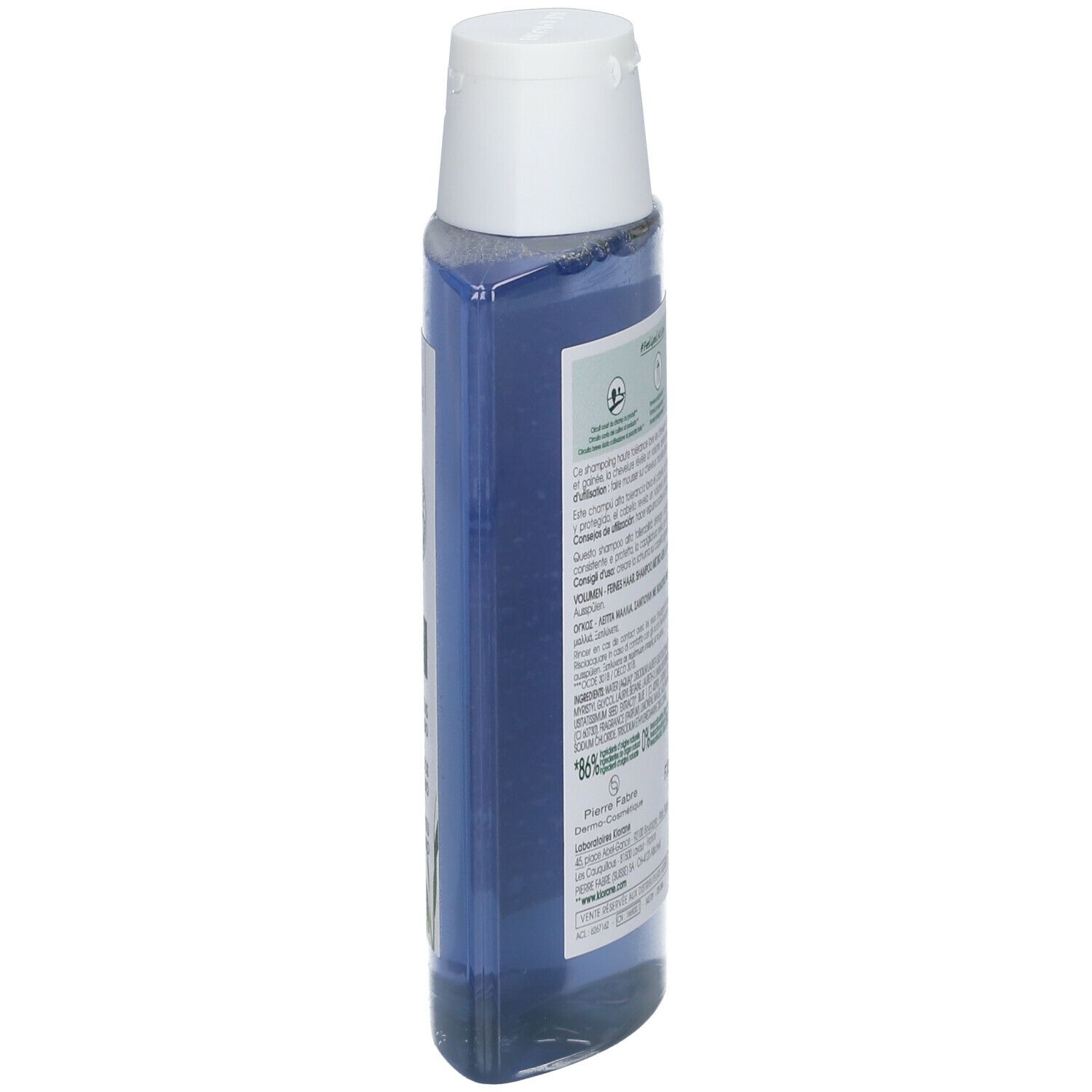 Flacone di shampoo blu, vista laterale. Tappo bianco, testo sul retro visibile.