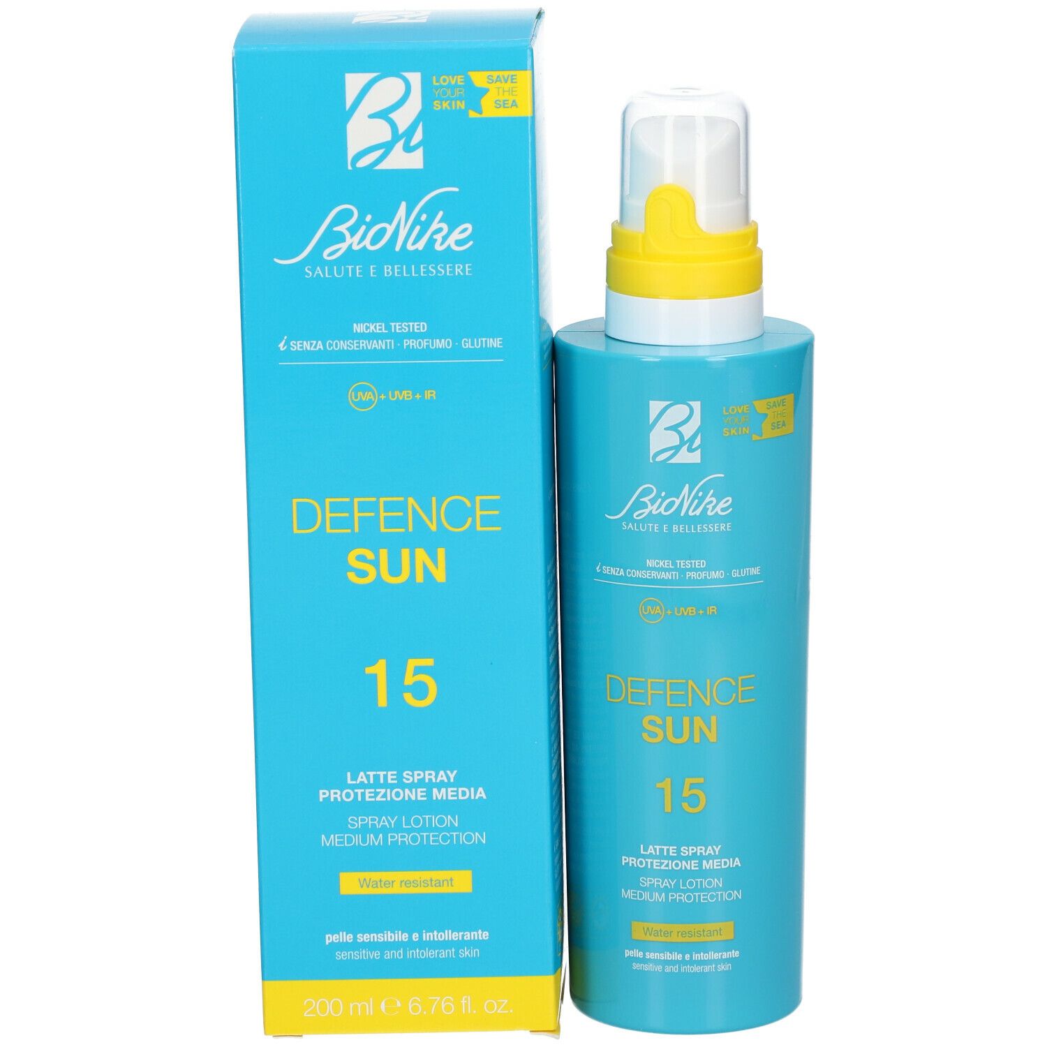 Flacone spray blu turchese e scatola. Scritta: Defence Sun 15, Latte Spray, protezione SPF 15. 200 ml.