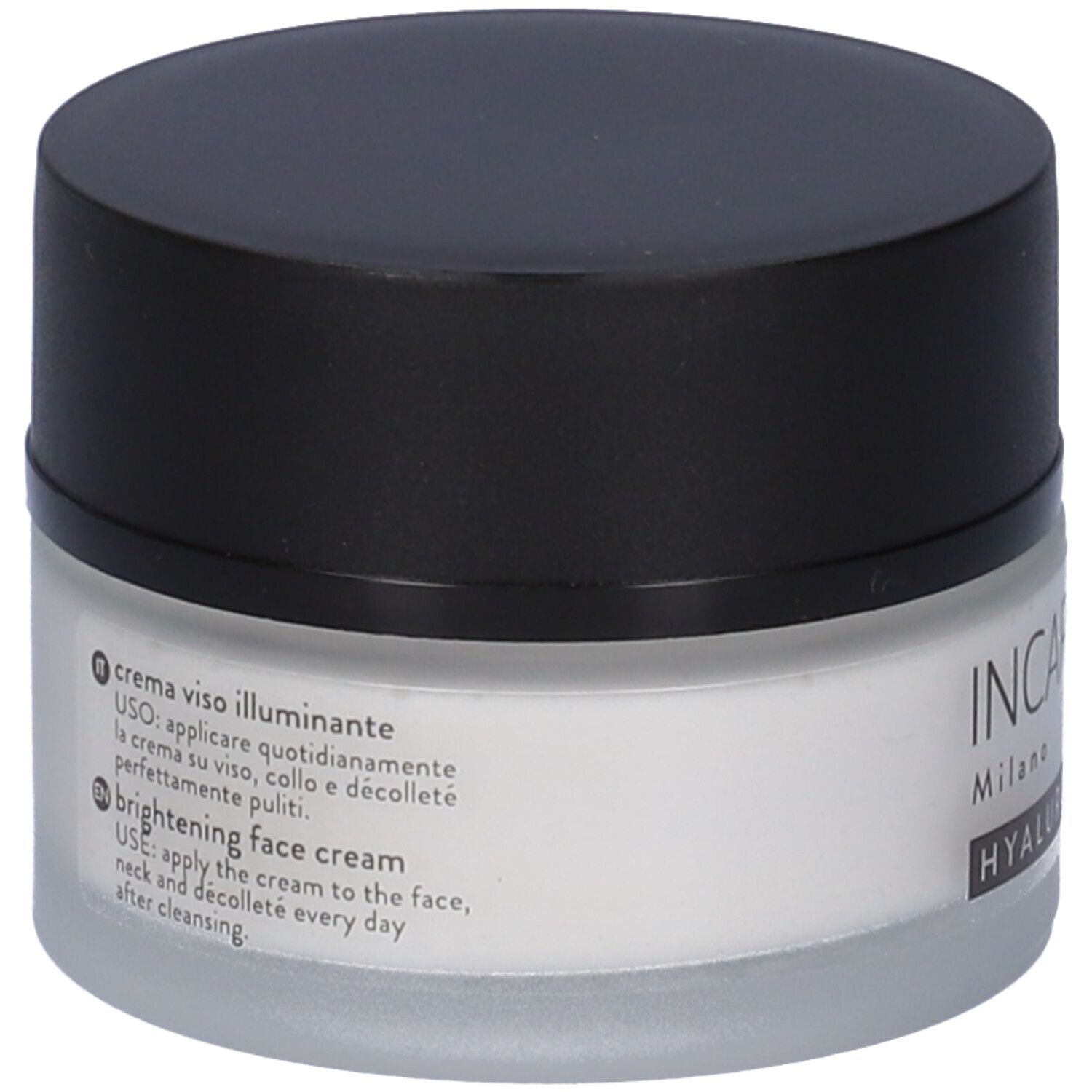 Vasetto di crema con coperchio nero. Testo: crema viso illuminante, brightening face cream.