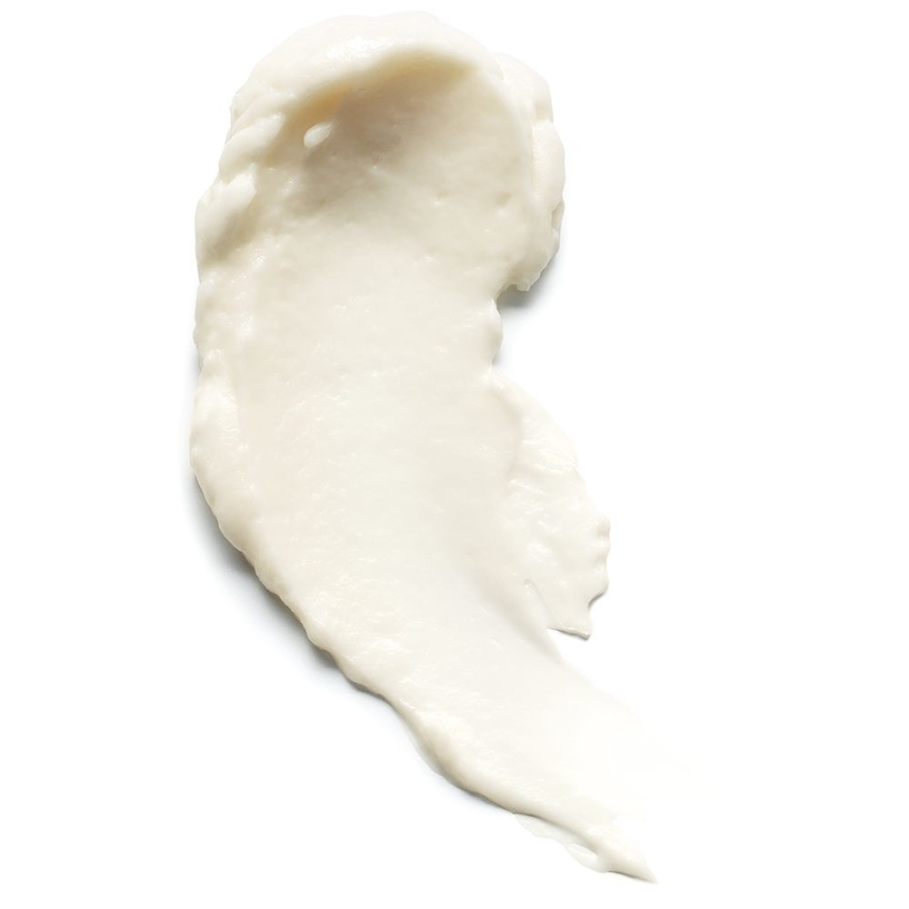 Macchia di crema bianca su sfondo bianco. Consistenza visibile.
