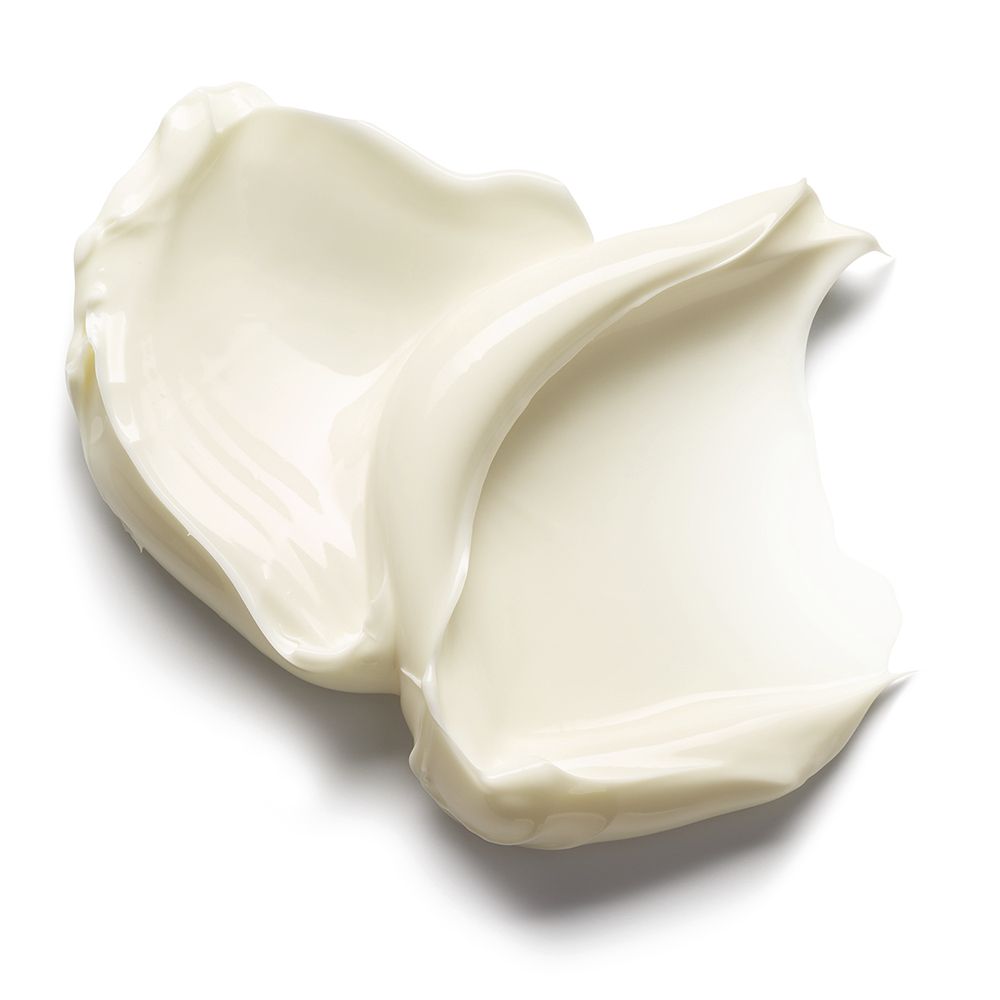 Due macchie di burro corpo bianco cremoso collegate. Superficie liscia.