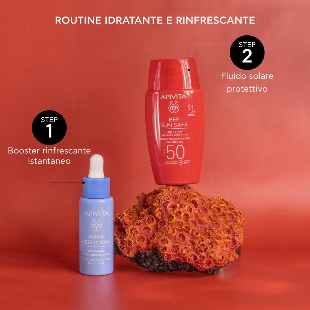 Due flaconi su una pietra. Scritta: APIVITA, BEE SUN SAFE, SPF 50. Fase 1: Booster. Fase 2: Protezione solare.