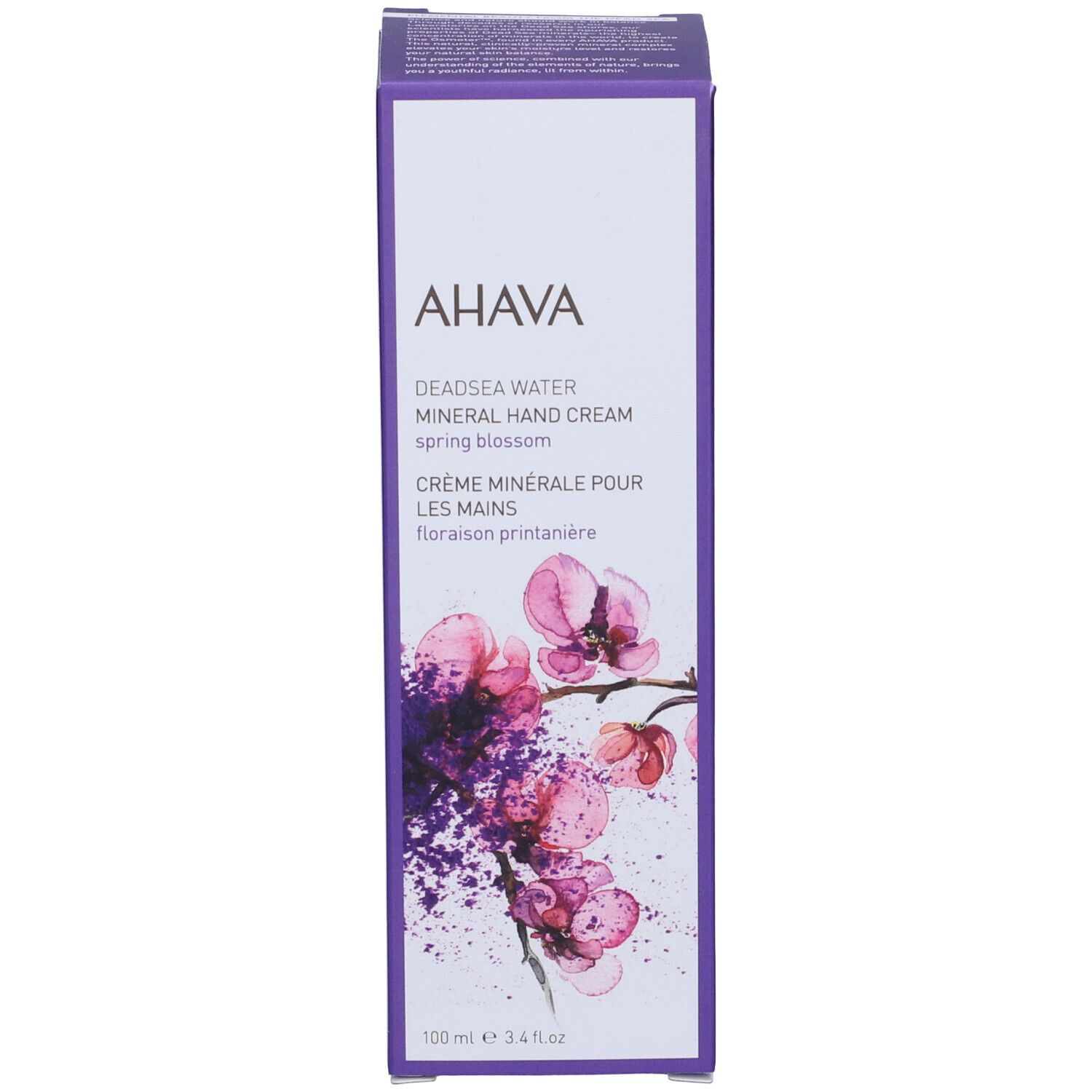 Scatola crema mani AHAVA. Scritta: Deadsea Water Mineral Hand Cream Spring Blossom. Lilla e bianco, con fiore.