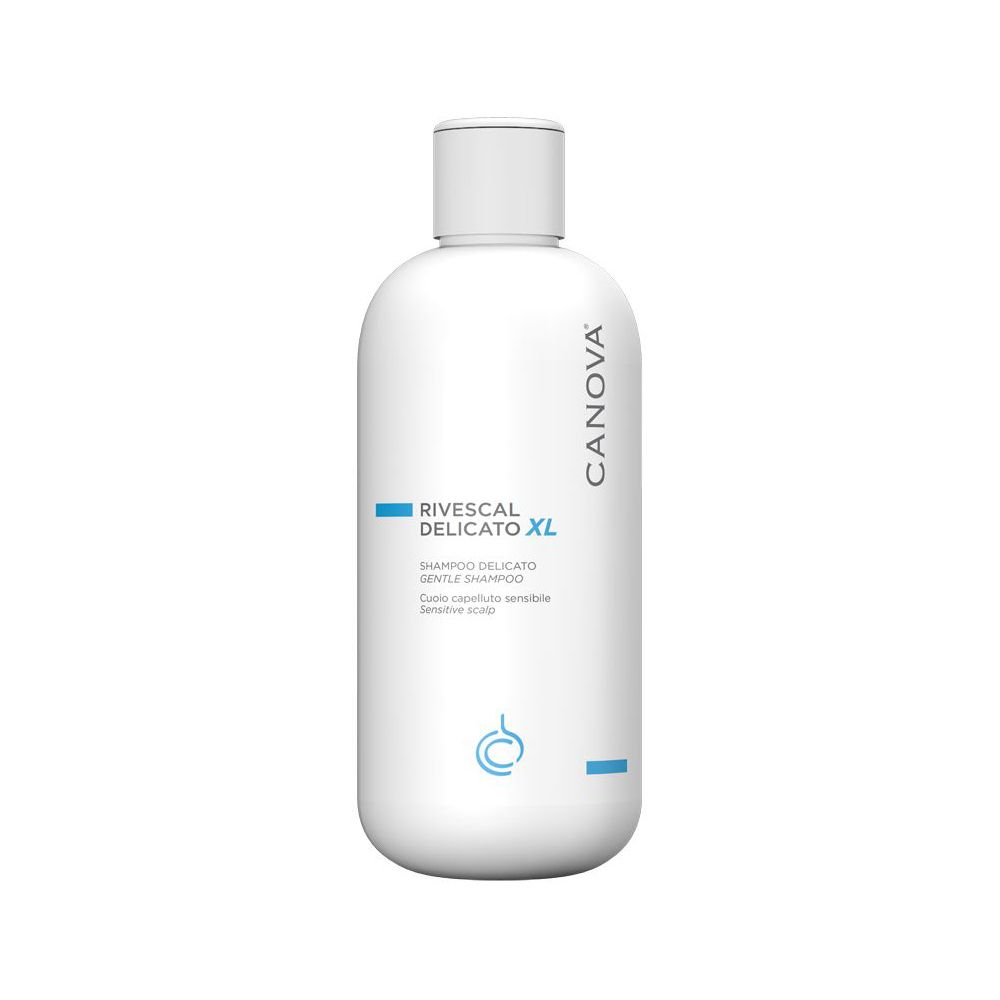 Flacone bianco con etichetta blu. Scritta: Rivescal Delicato XL, Shampoo. Marchio Canova.
