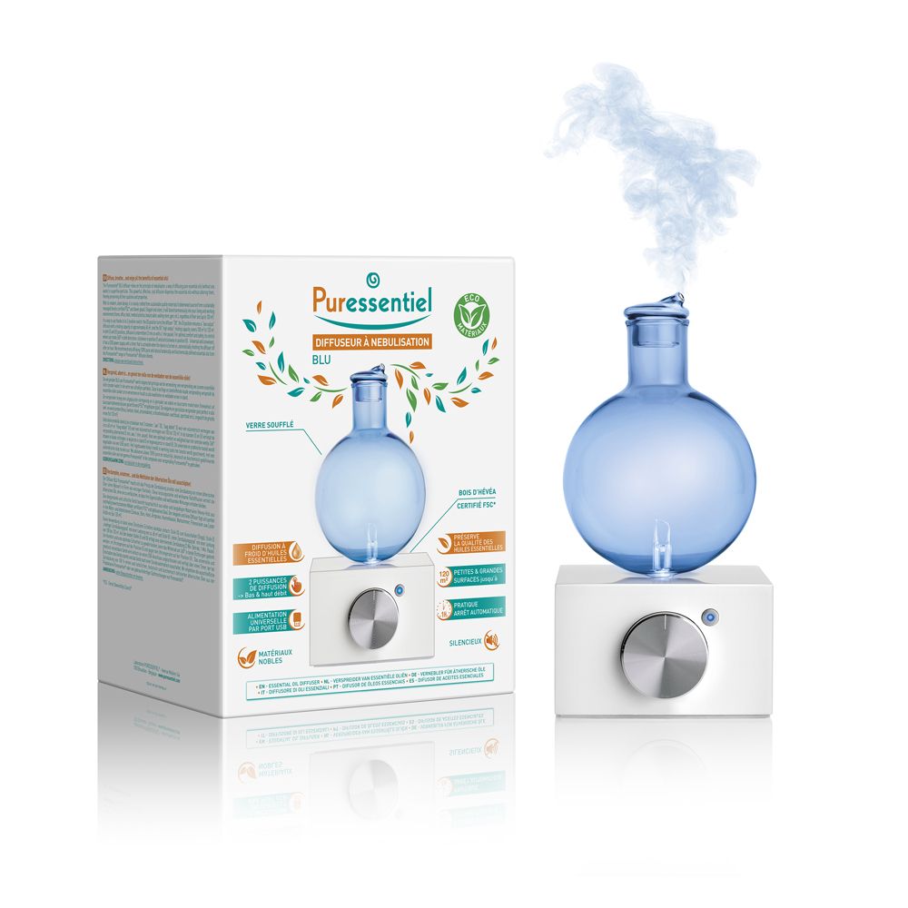Diffusore blu con base bianca. Vapore che sale. Confezione con immagine e testo del prodotto.