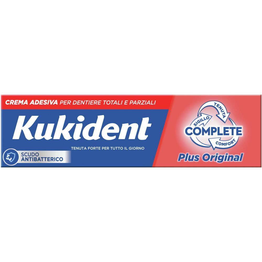 Tubo di crema adesiva per dentiere. Scritto: Kukident, Complete Plus Original. Protezione antibatterica.