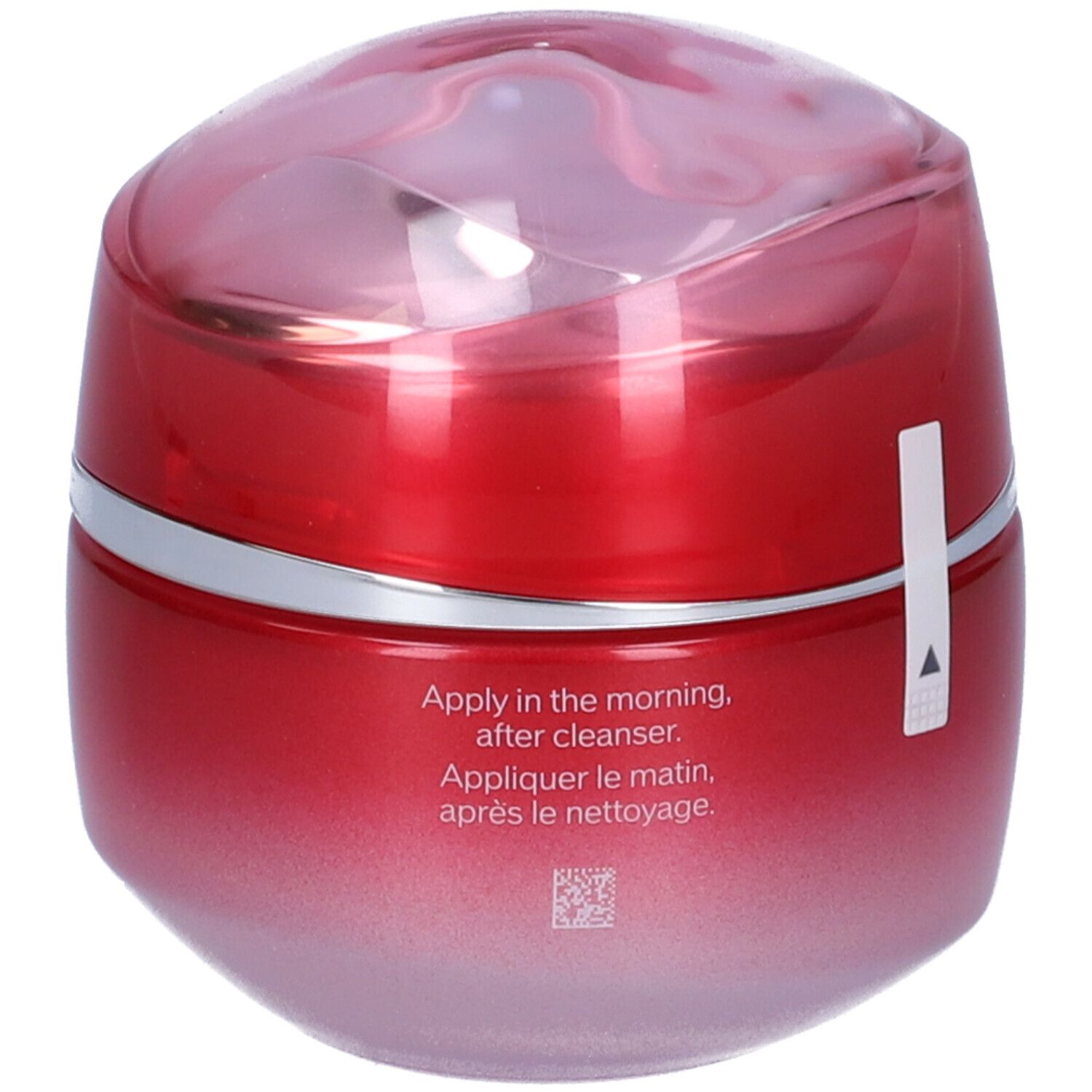 Vasetto rosso con coperchio. Anello argentato. Adesivo con freccia. Testo: Apply in the morning, after cleanser.