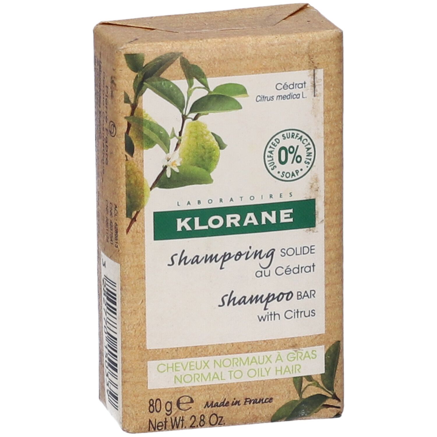 Shampoo solido Klorane in confezione marrone. Vista dall'alto. Informazioni e illustrazioni visibili.