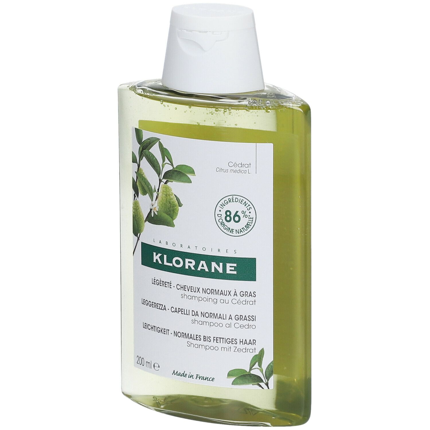 Flacone di shampoo Klorane, leggermente inclinato. Liquido giallo, tappo bianco. Etichetta con nome e ingredienti.