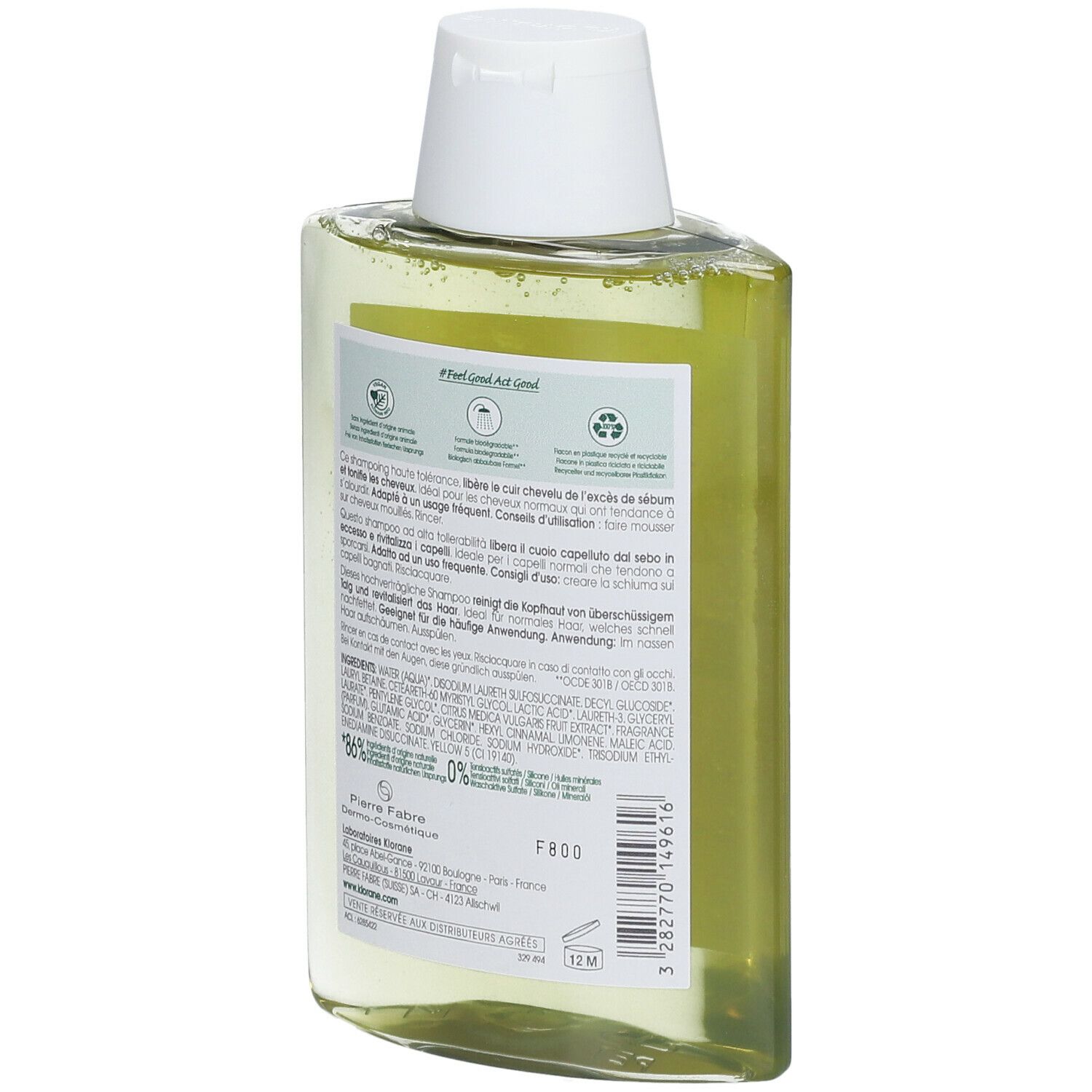 Retro del flacone di shampoo Klorane inclinato. Informazioni testuali e loghi. Simboli di riciclo e ambientali.