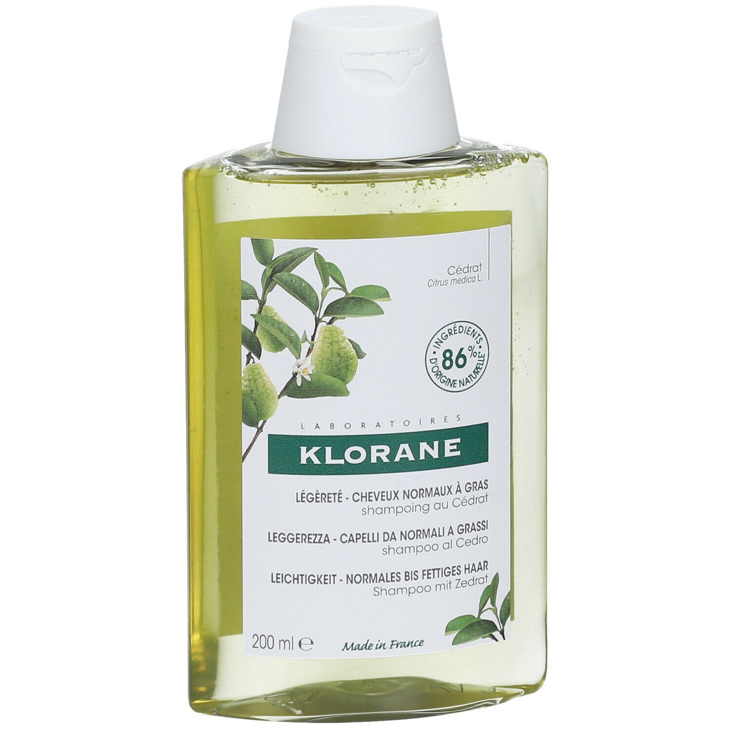 Flacone di shampoo Klorane, leggermente inclinato. Liquido giallo, tappo bianco. Etichetta con nome e ingredienti.