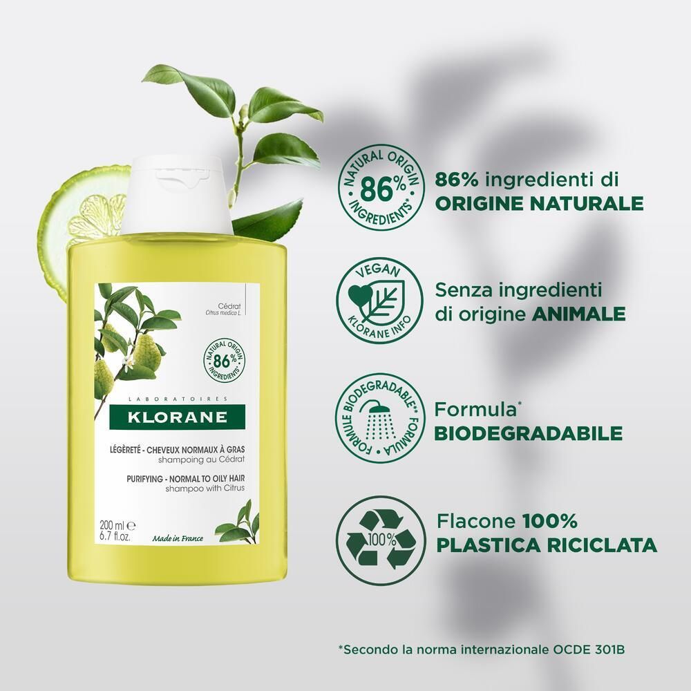 Flacone di shampoo Klorane con loghi e testo. 86% ingredienti di origine naturale. Sigilli vegan e riciclo.