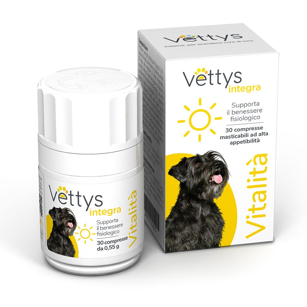Flacone e scatola bianchi. Prodotto per cani Vettys integra Vitalità. Immagine di un cane nero.