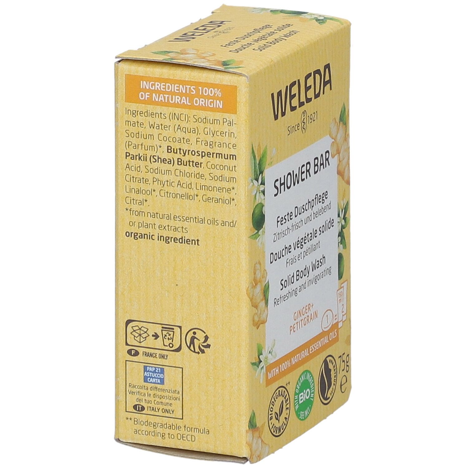 Vista laterale della confezione WELEDA, barra doccia solida. Gialla, informazioni, zenzero e fiori.