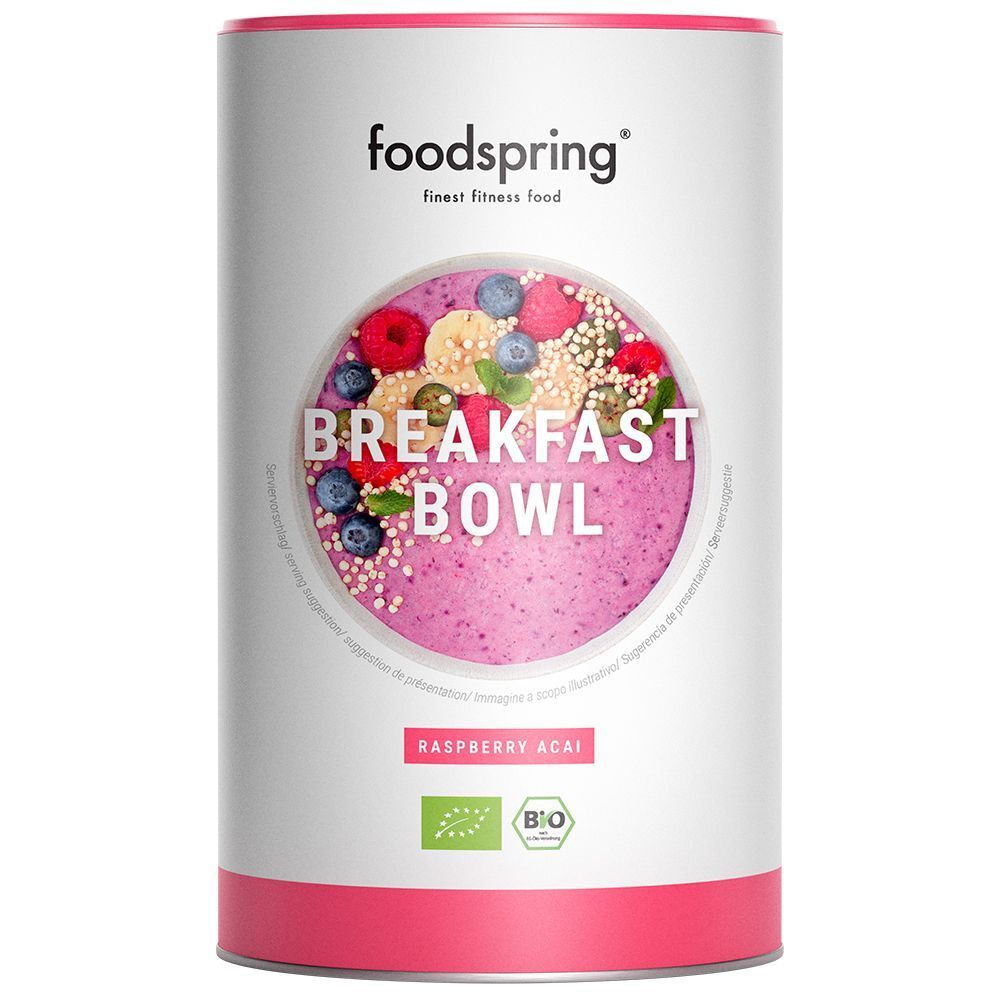 Barattolo Foodspring Breakfast Bowl. Coperchio e base rossi, etichetta con frutta e testo. Sigillo biologico.