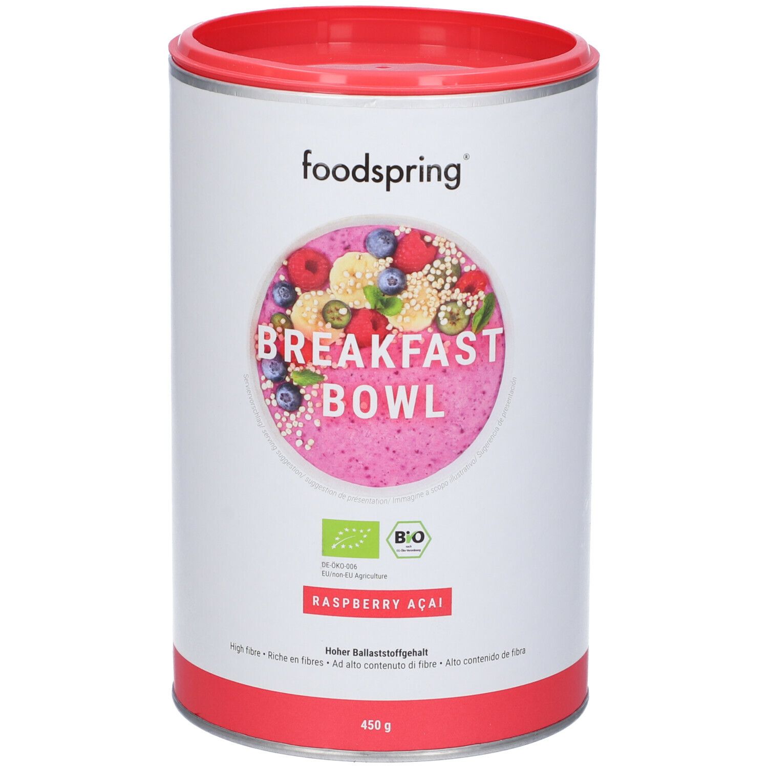 Barattolo Foodspring Breakfast Bowl. Coperchio e base rossi. Etichetta con frutta, testo e 450g. Sigillo biologico.