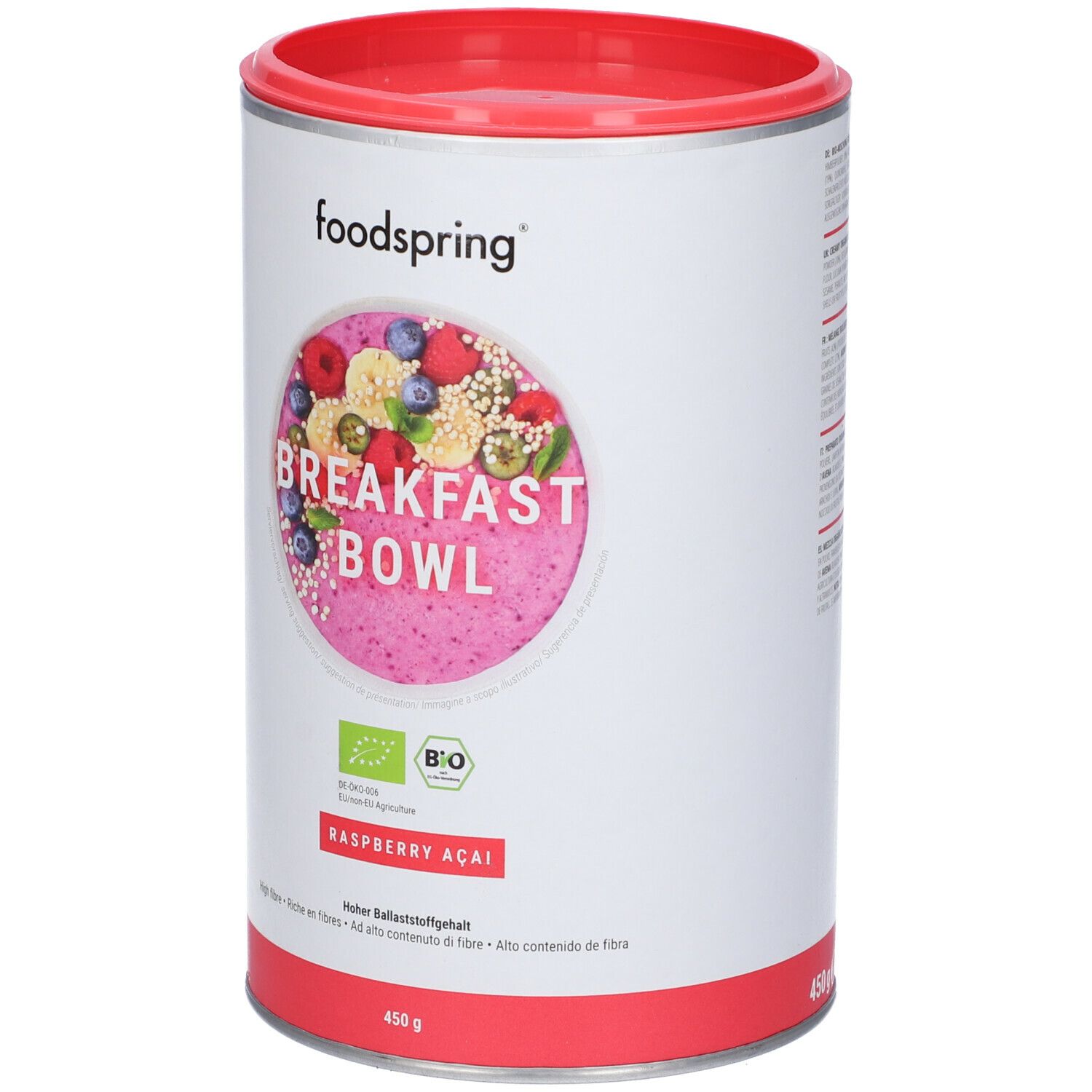 Barattolo Foodspring Breakfast Bowl. Coperchio e base rossi. Etichetta con frutta, testo e 450g. Sigillo biologico.