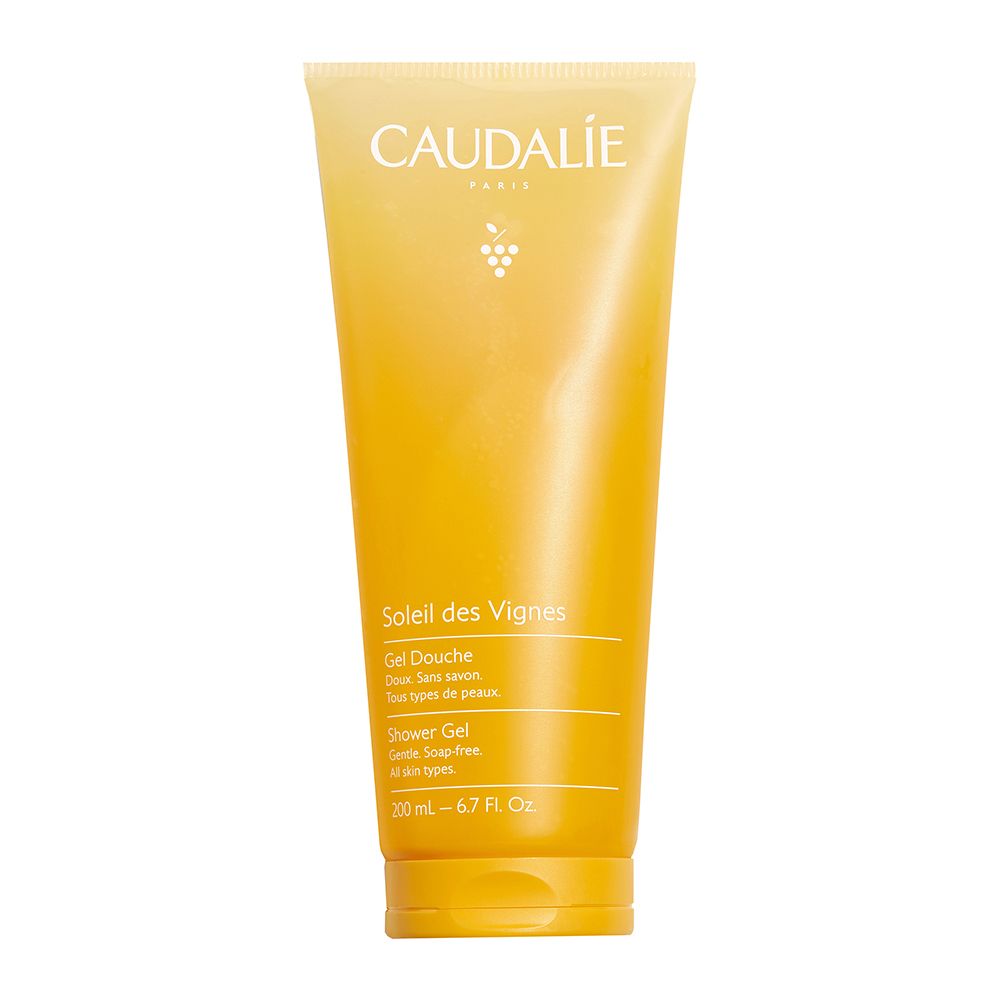 Tubo gel doccia sfumato giallo-arancio. Scritta Caudalie, Soleil des Vignes. Testo: Douche, sans savon, tous types de peaux.