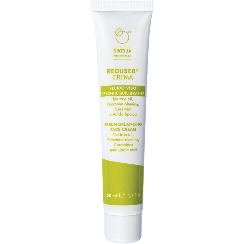 Tubo bianco con etichetta verde. Scritta: Reduseb Crema, Fluido Viso, Serum-Balancing Face Cream. Contiene Tea Tree Oil.