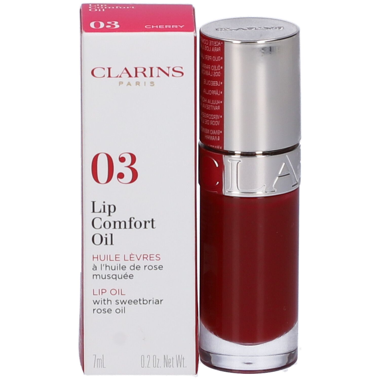 Olio labbra e confezione. Olio rosso in flacone, accanto scatola con informazioni prodotto e logo Clarins.