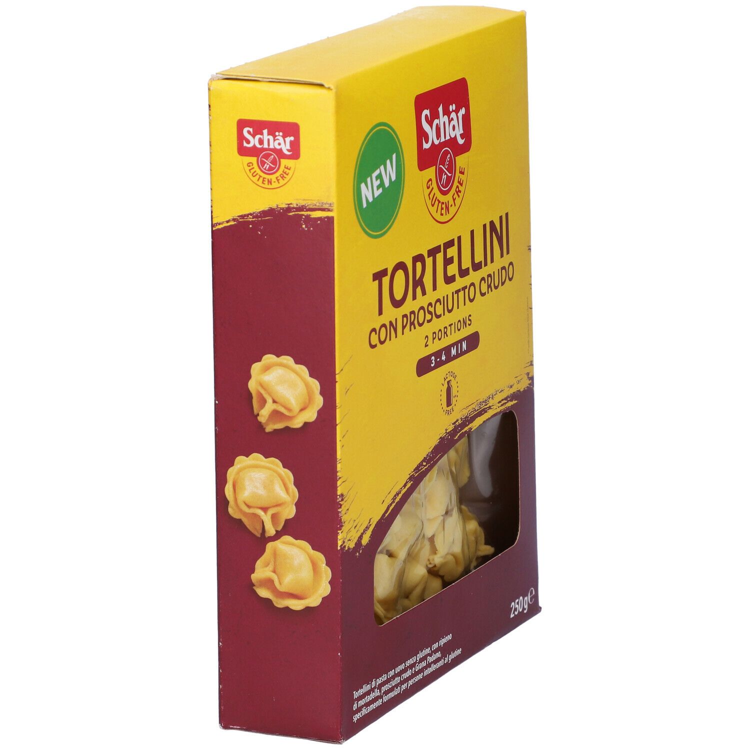 Scatola gialla di tortellini. Scritto: Schar, senza glutine, Tortellini con Prosciutto Crudo, 2 porzioni, 3-4 min. Finestra con tortellini.