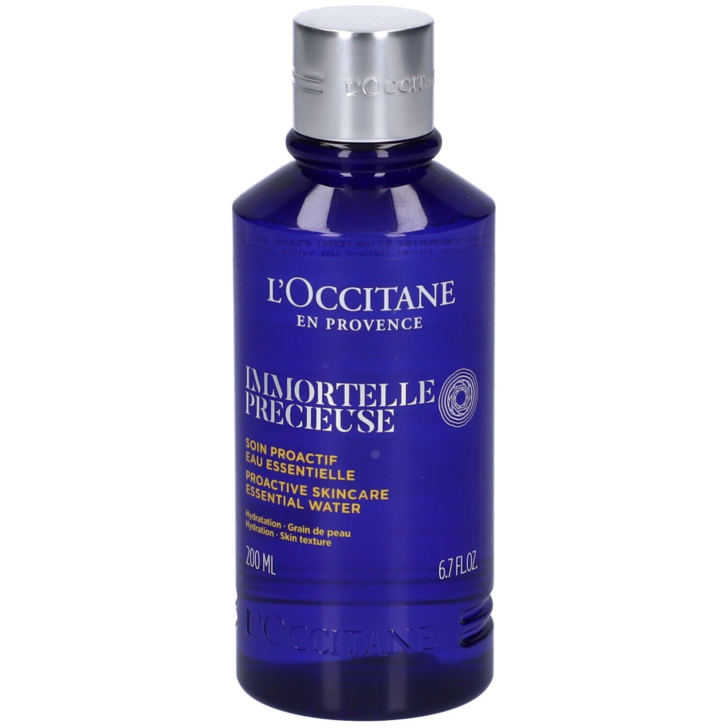 Blauwe Flasche mit silbernem Deckel. Aufschrift: L'Occitane, Immortelle Précieuse, 200 ml, 6.7 FL.OZ.